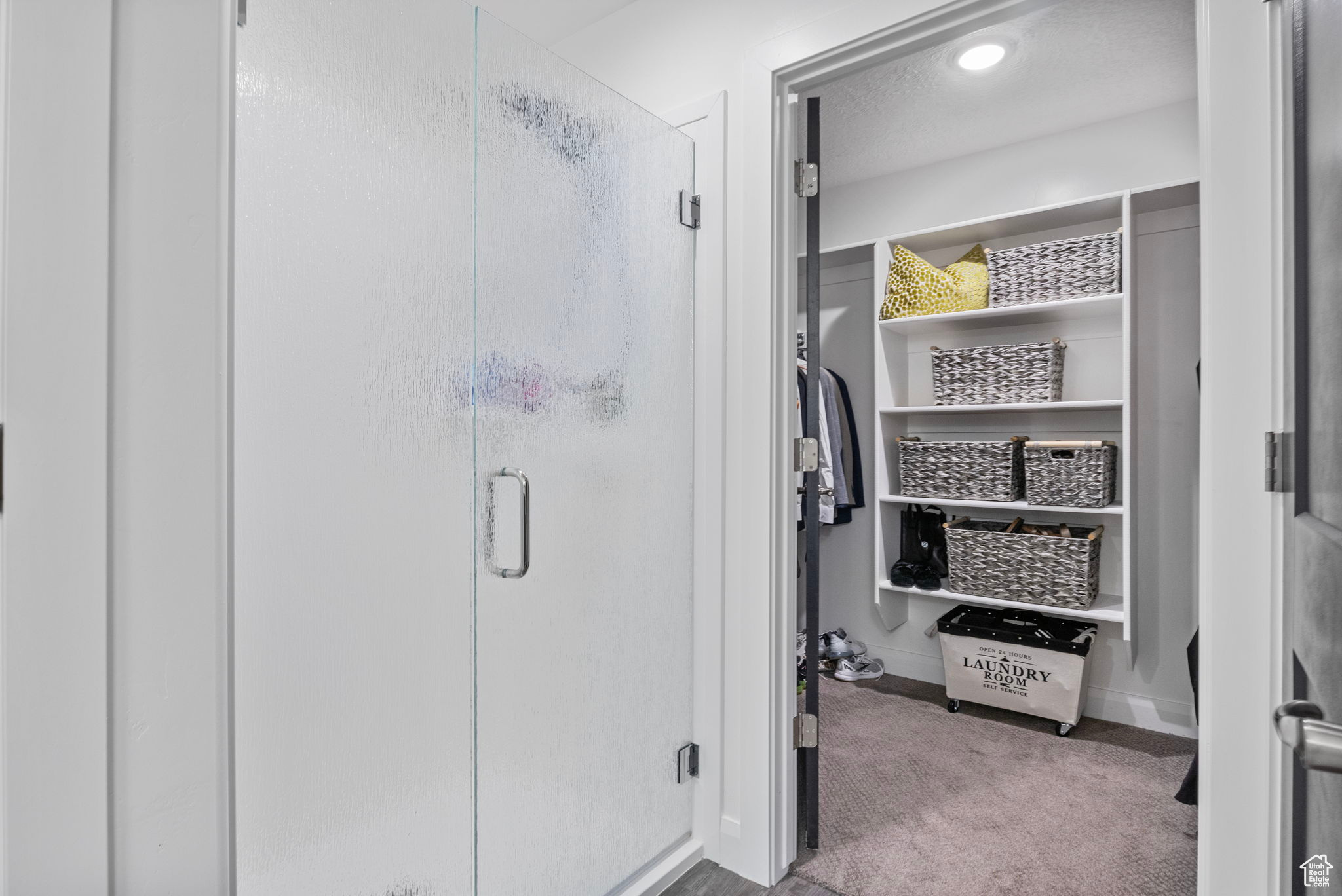 Bathroom featuring an enclosed shower and a textured ceiling