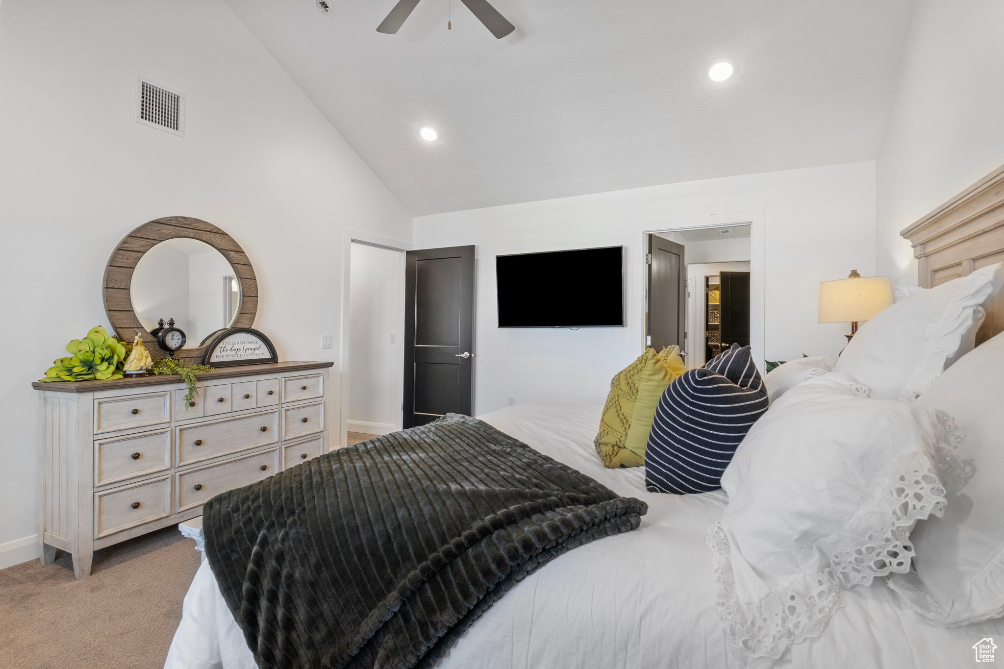 Bedroom with light carpet, high vaulted ceiling, and ceiling fan