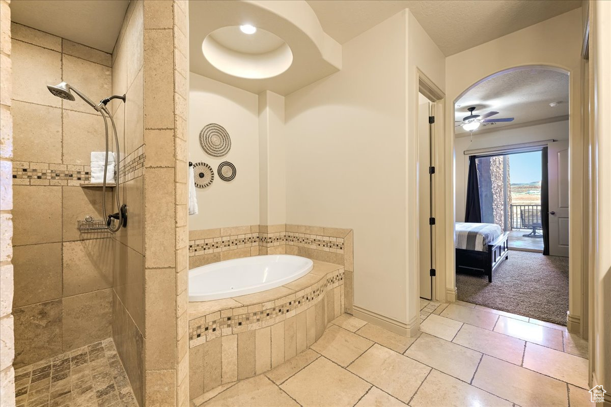 Bathroom with ceiling fan and independent shower and bath