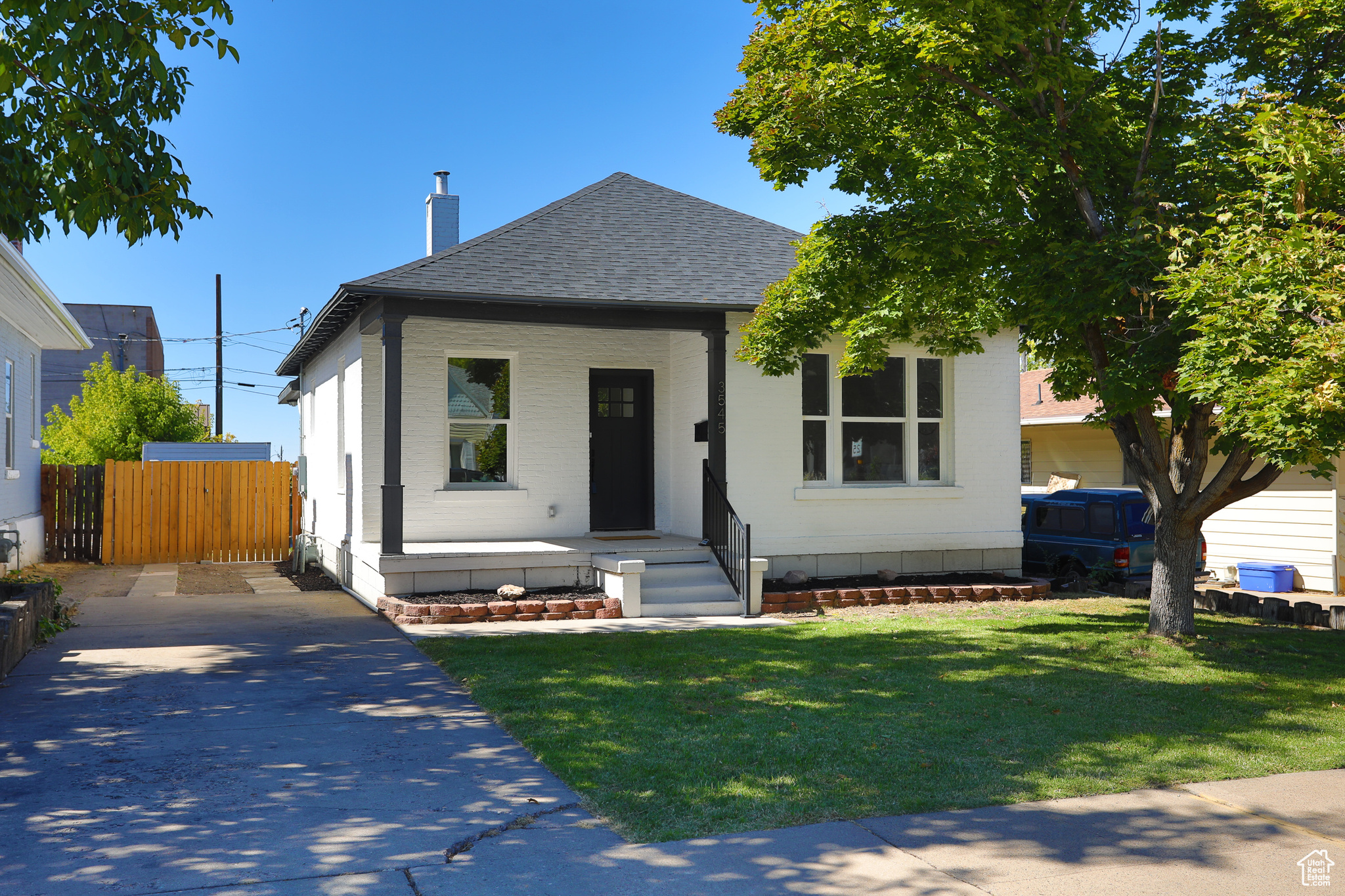 View of front of property with a porch and a front lawn