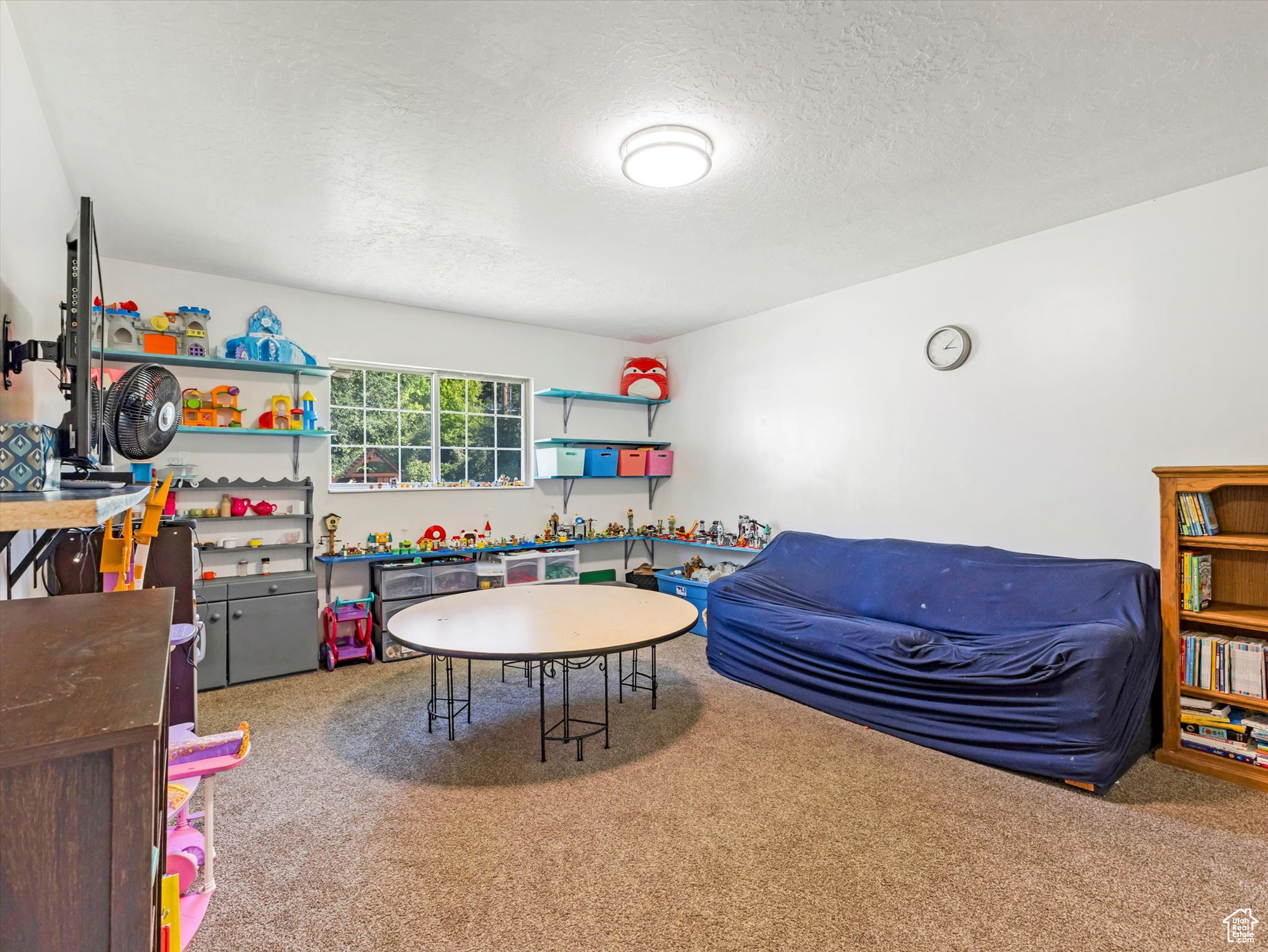 Bedroom #4 with carpet floors and a textured ceiling