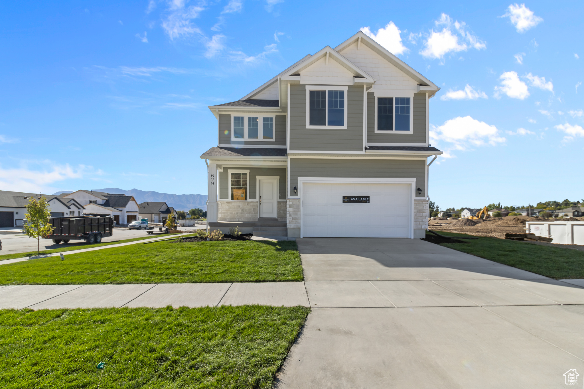 View of front of house with a garage and a front lawn