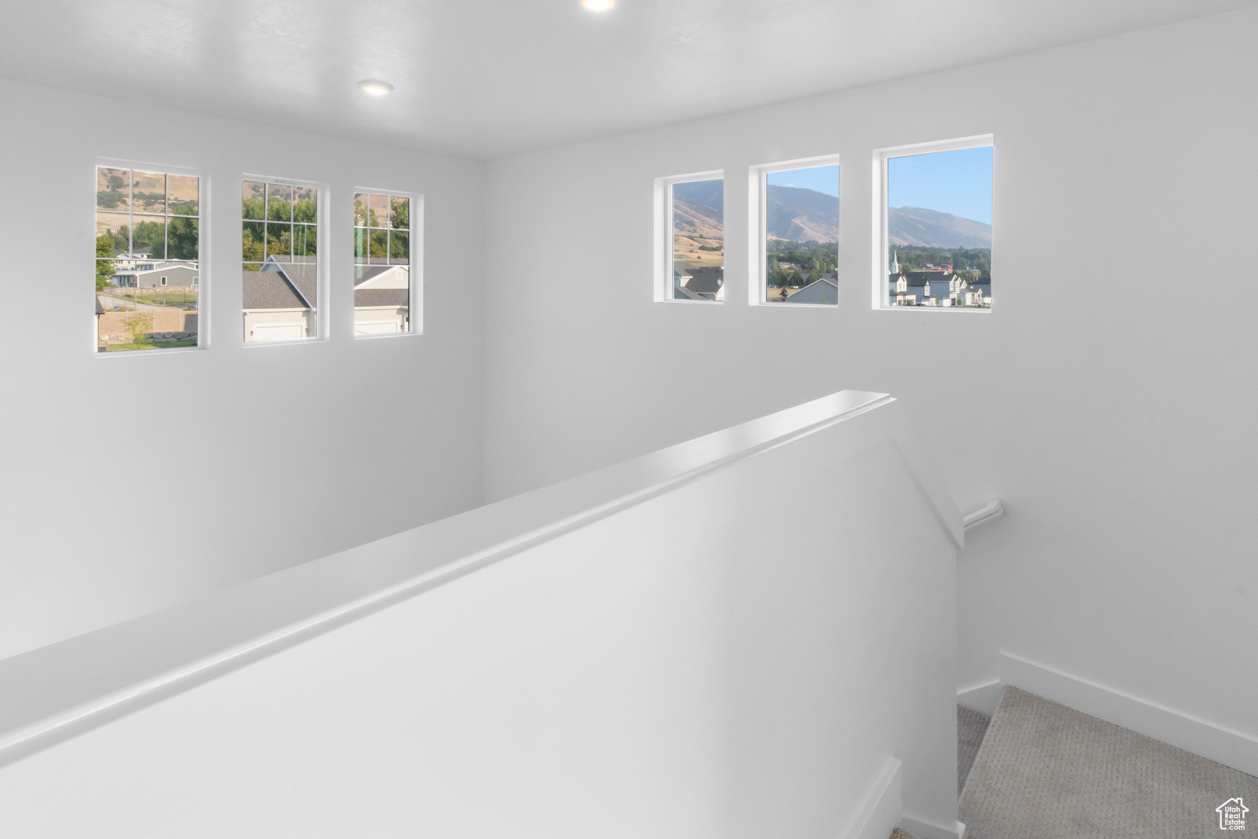 Hallway with carpet flooring and a mountain view