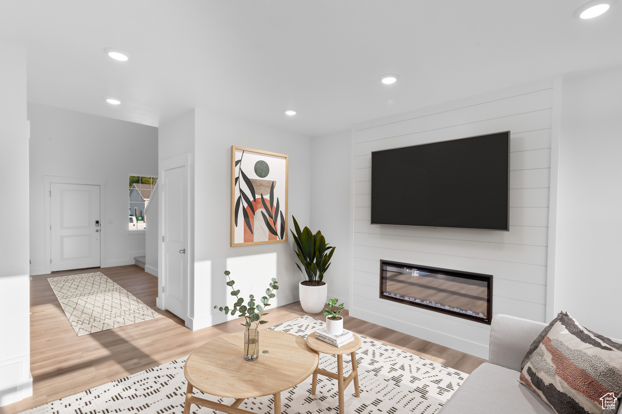 Living room featuring wood-type flooring and a fireplace