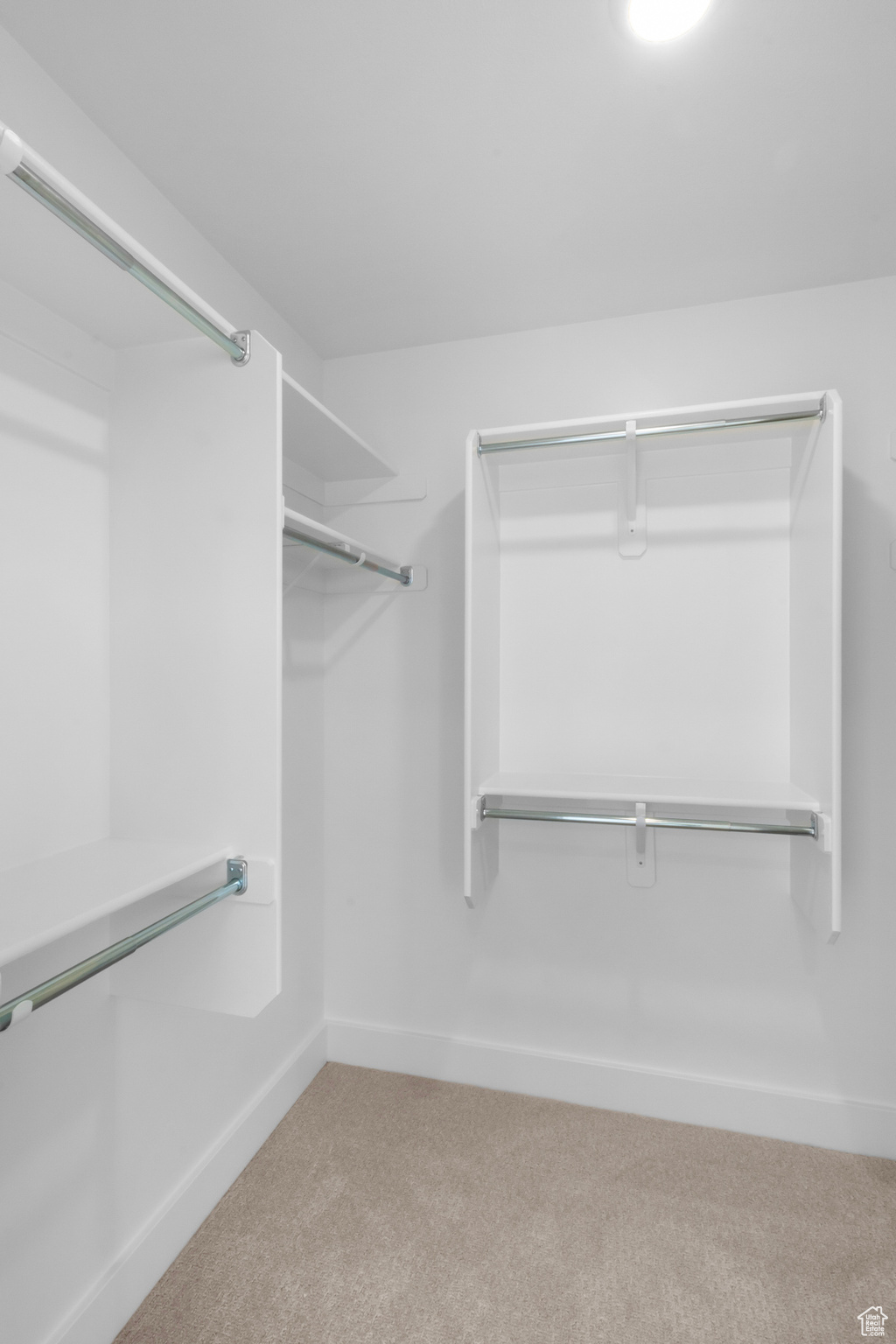 Walk in closet with carpet flooring