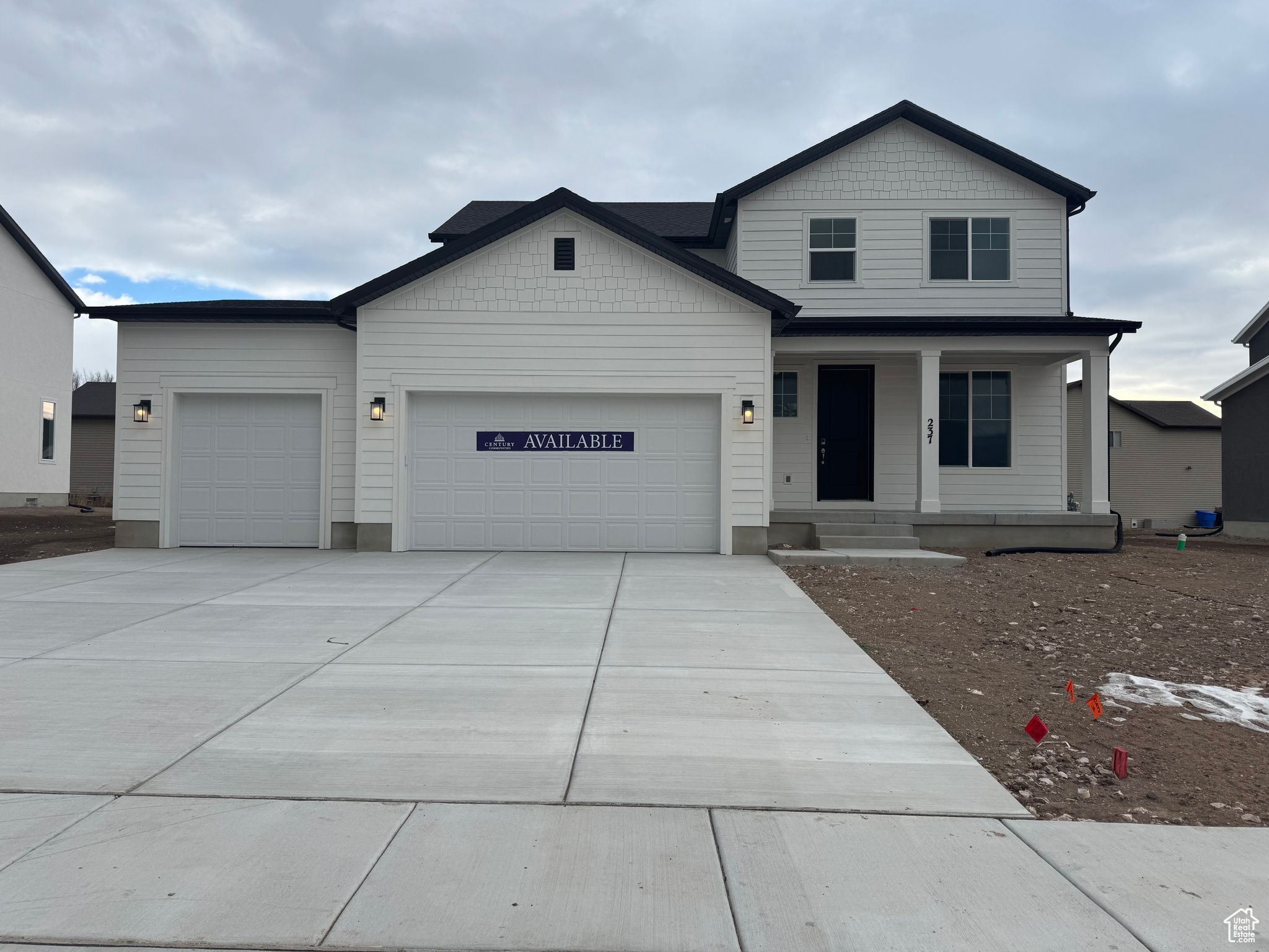 View of front of property featuring a porch and a 3 car garage