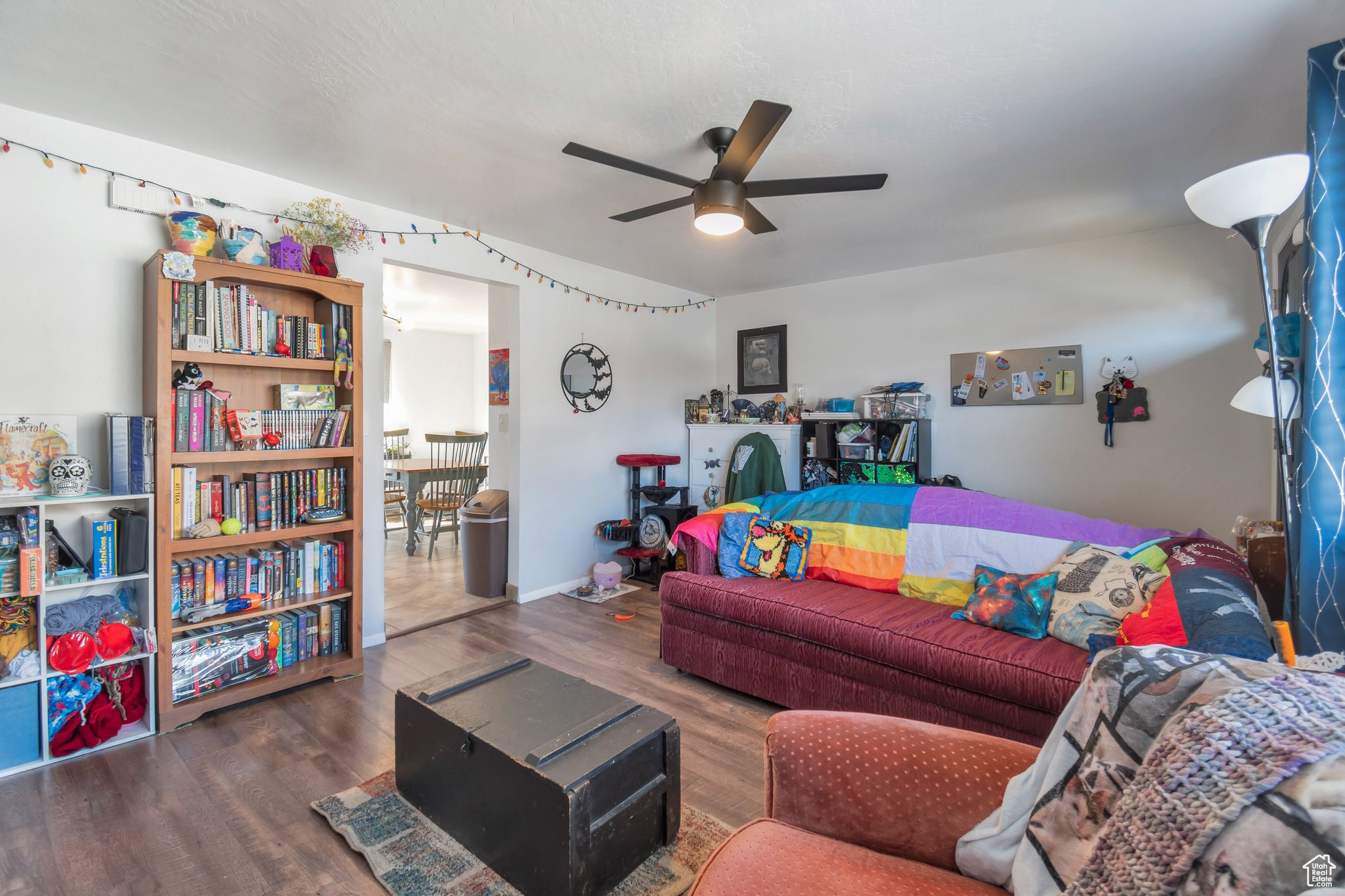 Living room with ceiling fan and dark hardwood / wood-style floors