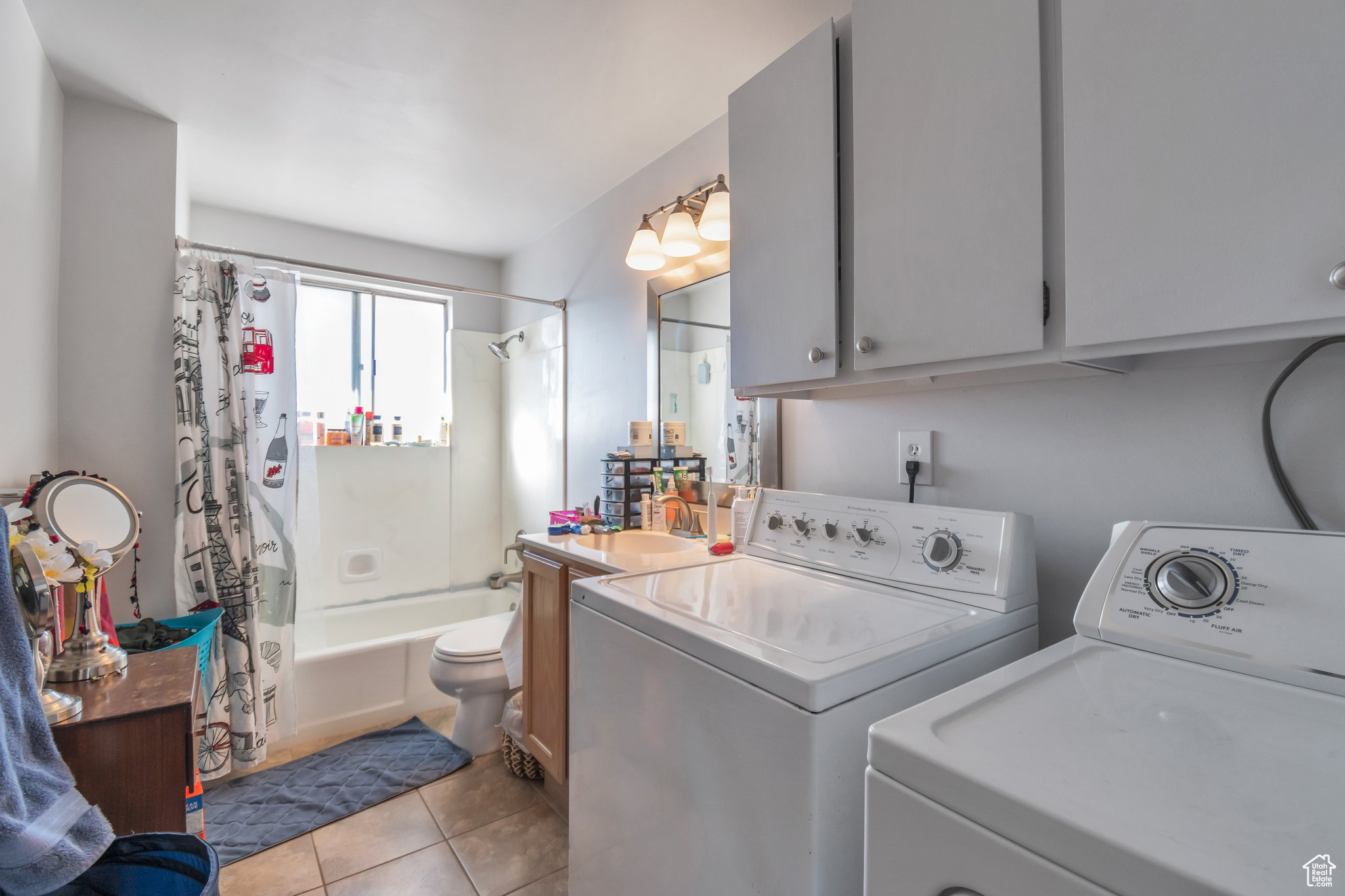 Laundry area with light tile patterned floors and washer and dryer