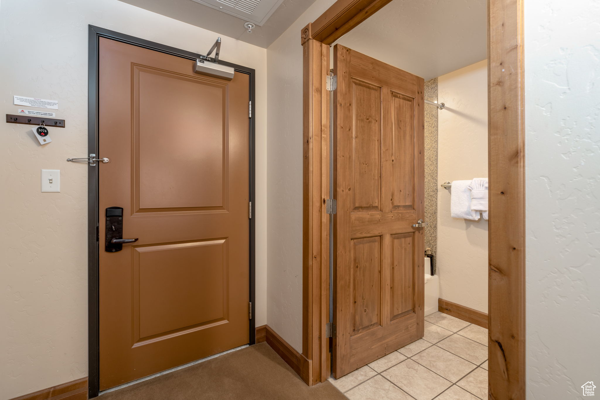 Hallway with light tile patterned floors