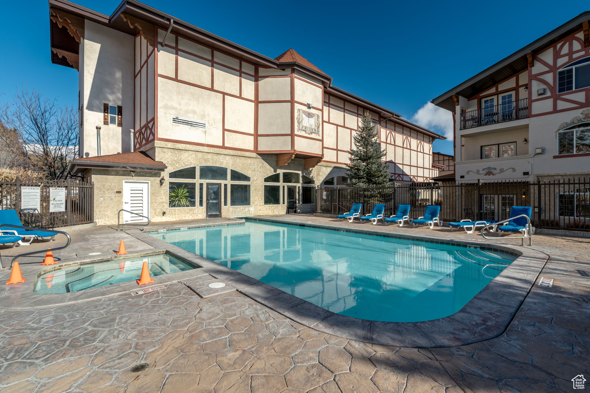 View of swimming pool with a patio area and a hot tub