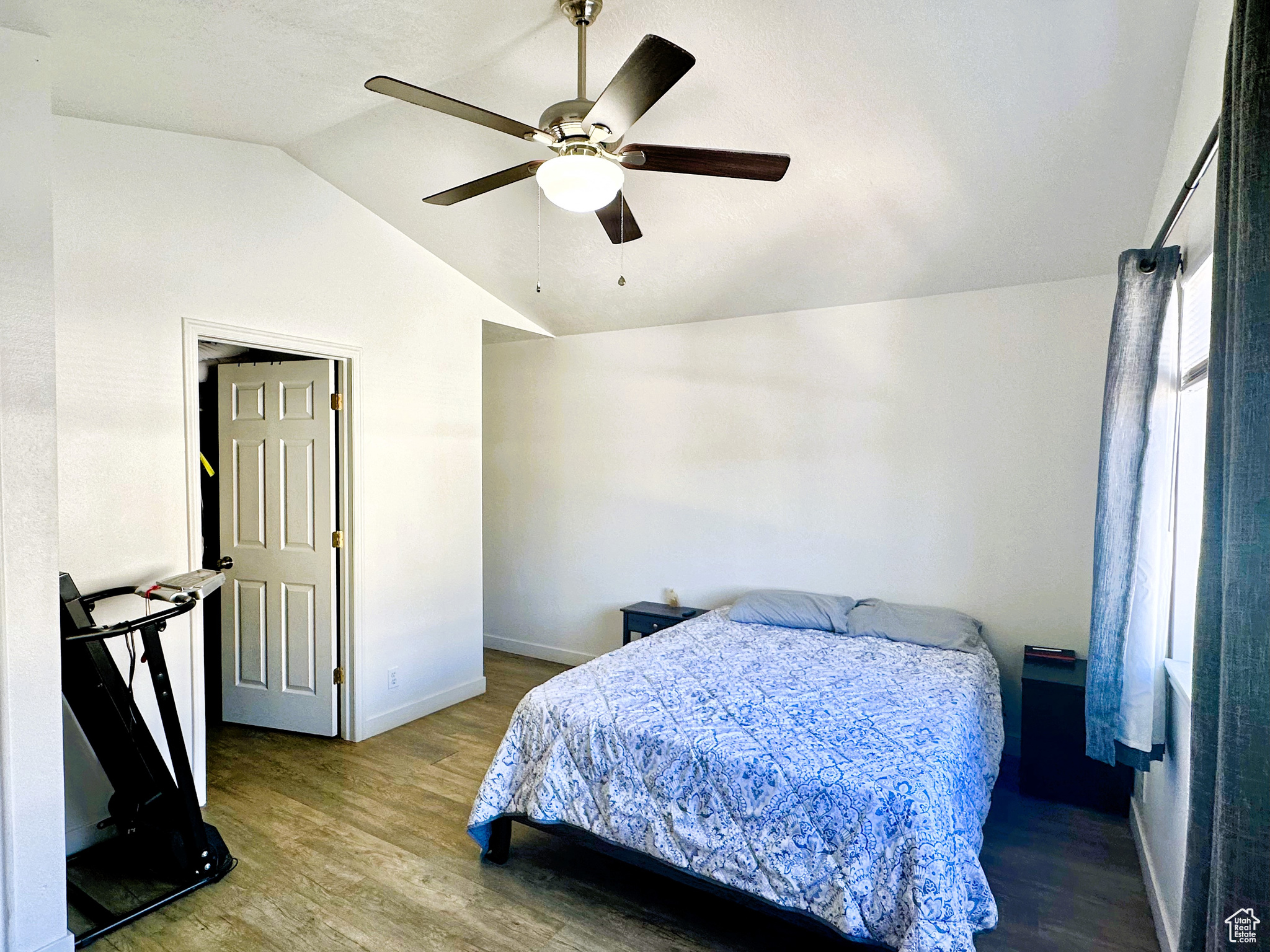 Primary Bedroom with ceiling fan, hardwood / wood-style floors, and lofted ceiling