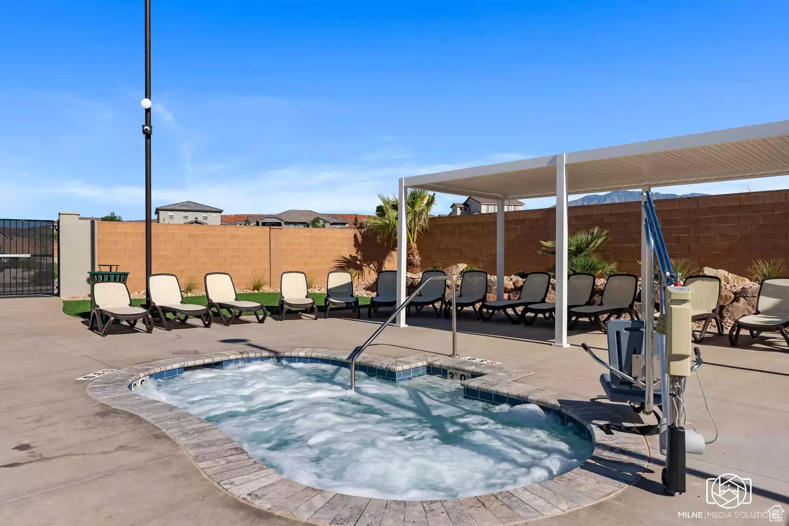 View of pool with a hot tub