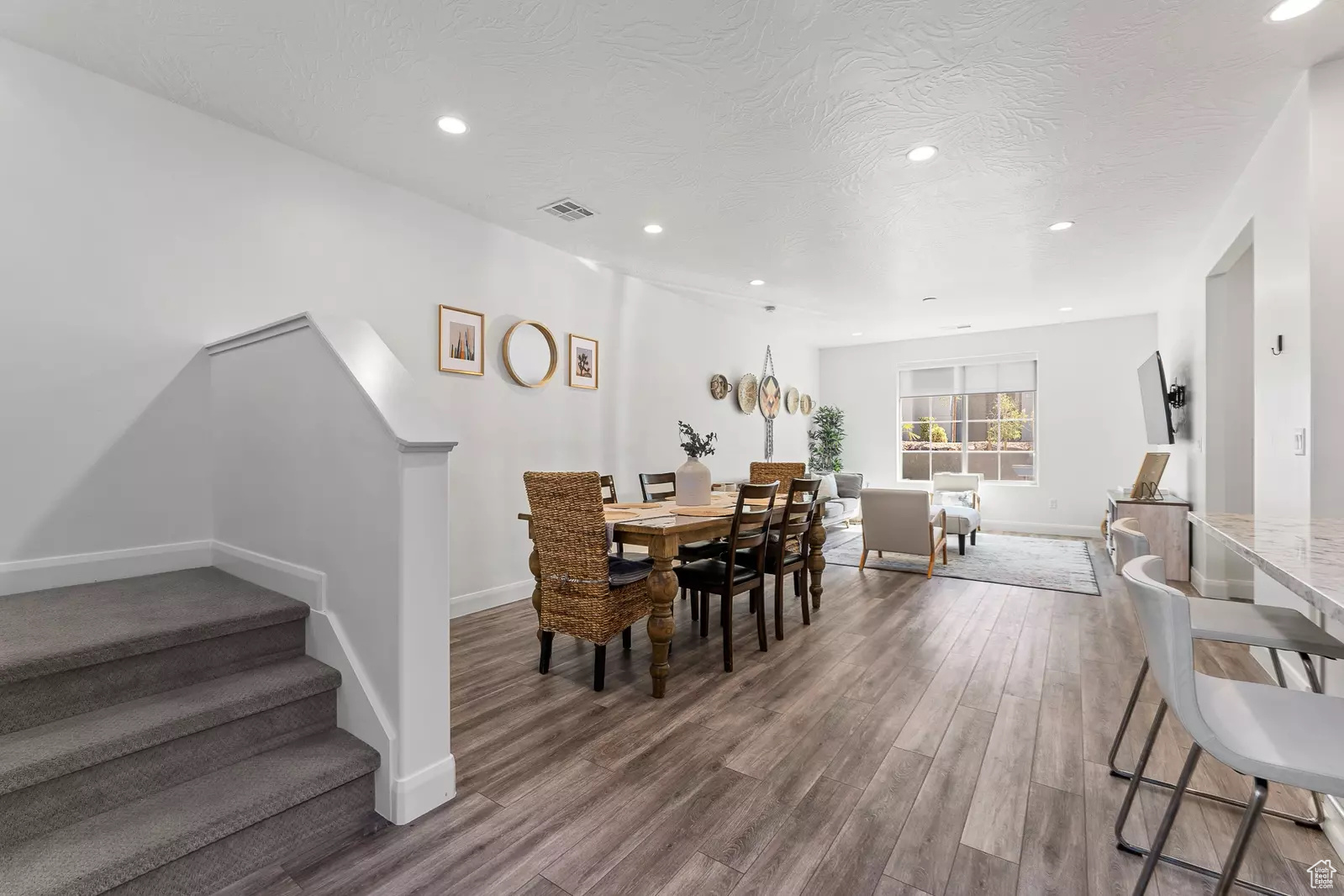Dining room featuring wood-type flooring and a textured ceiling