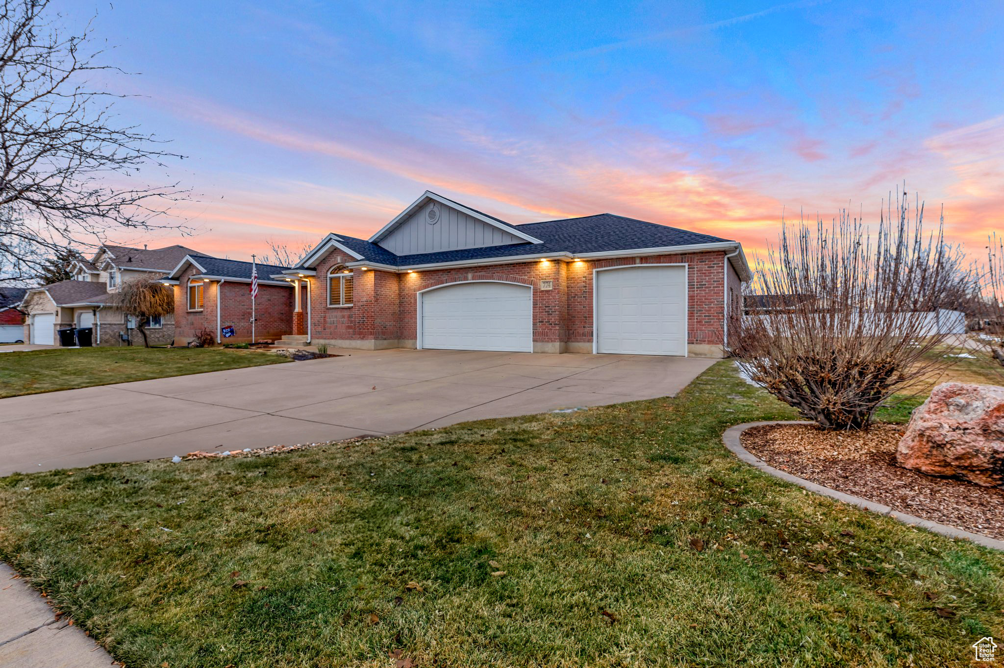 Ranch-style house with a lawn and a garage