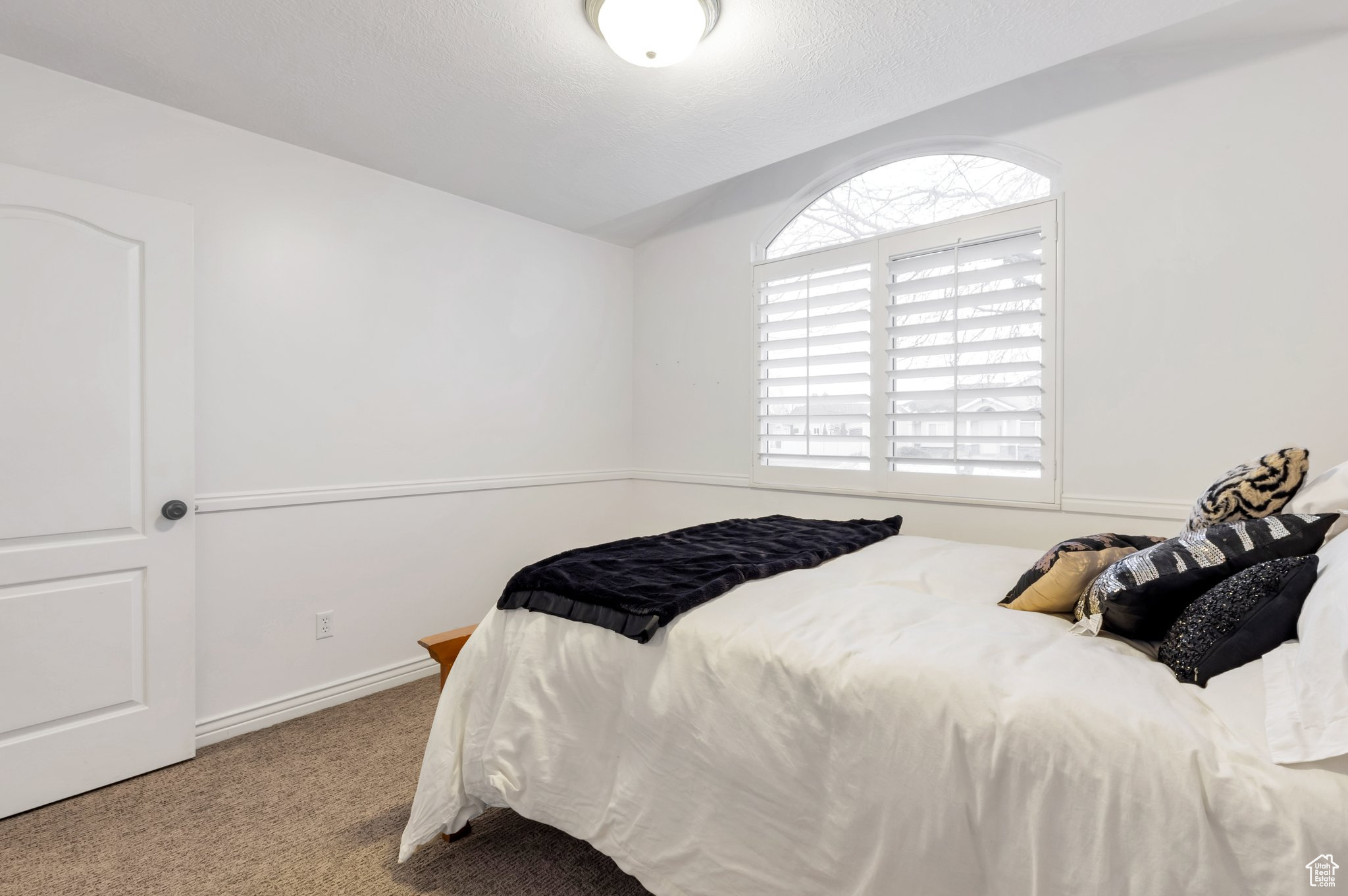 Bedroom with light carpet