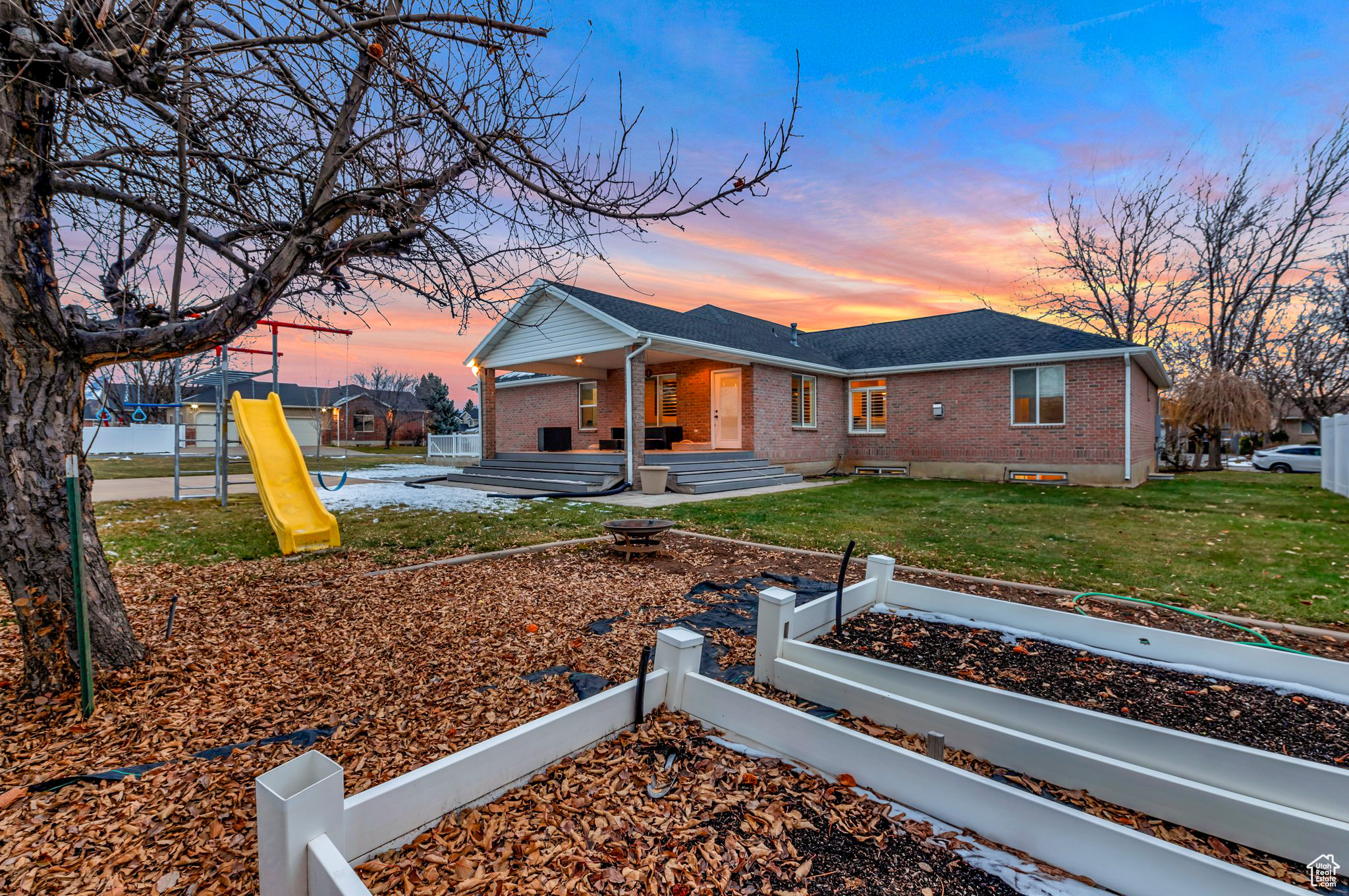 View of front of property featuring a playground and a yard