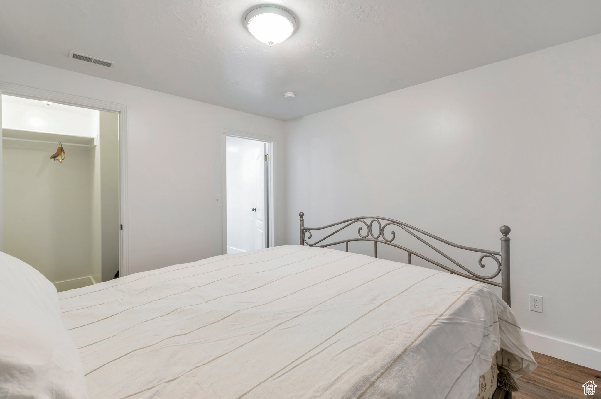 Bedroom featuring a closet and wood-type flooring