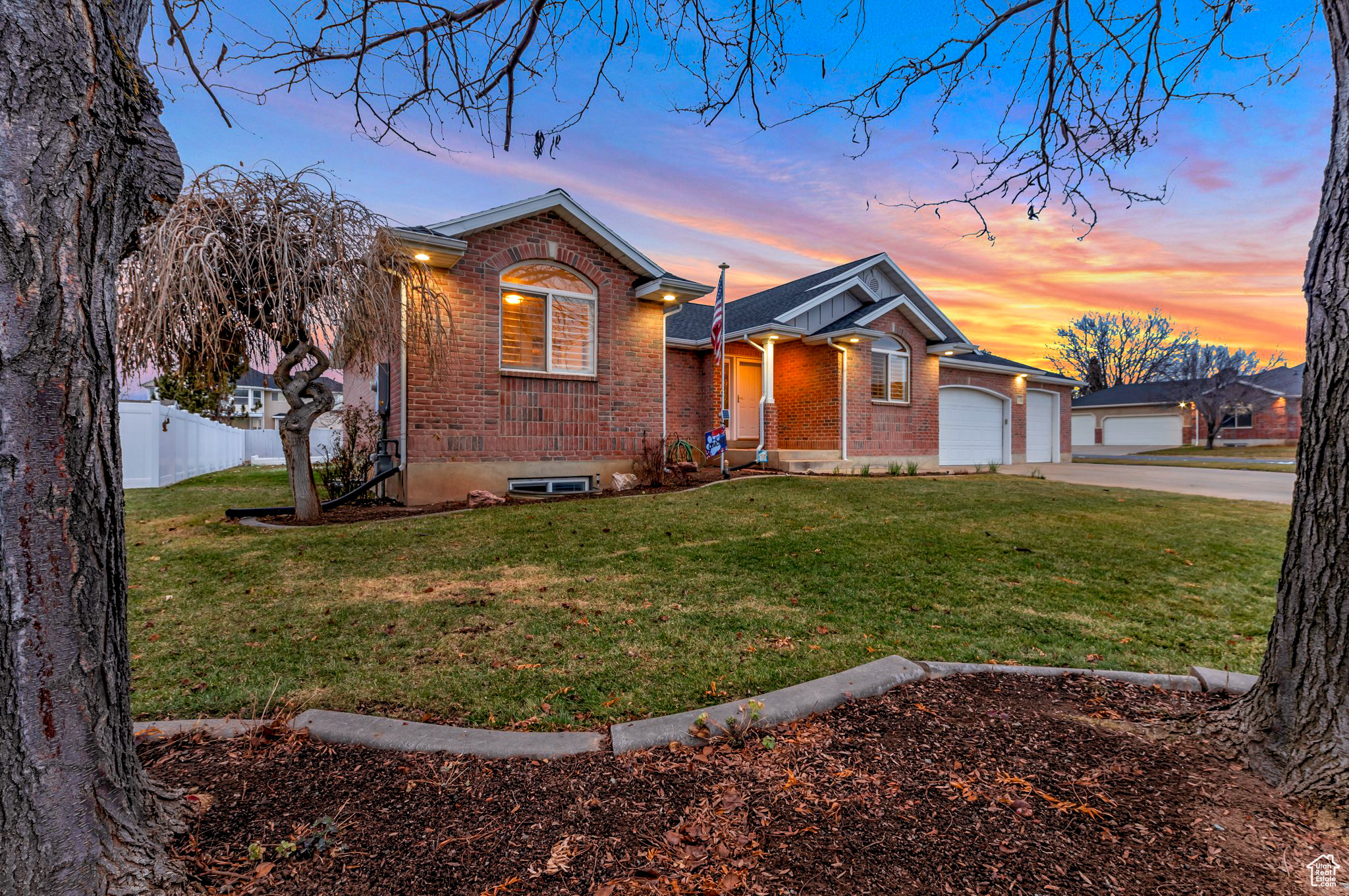 Ranch-style house featuring a yard and a garage