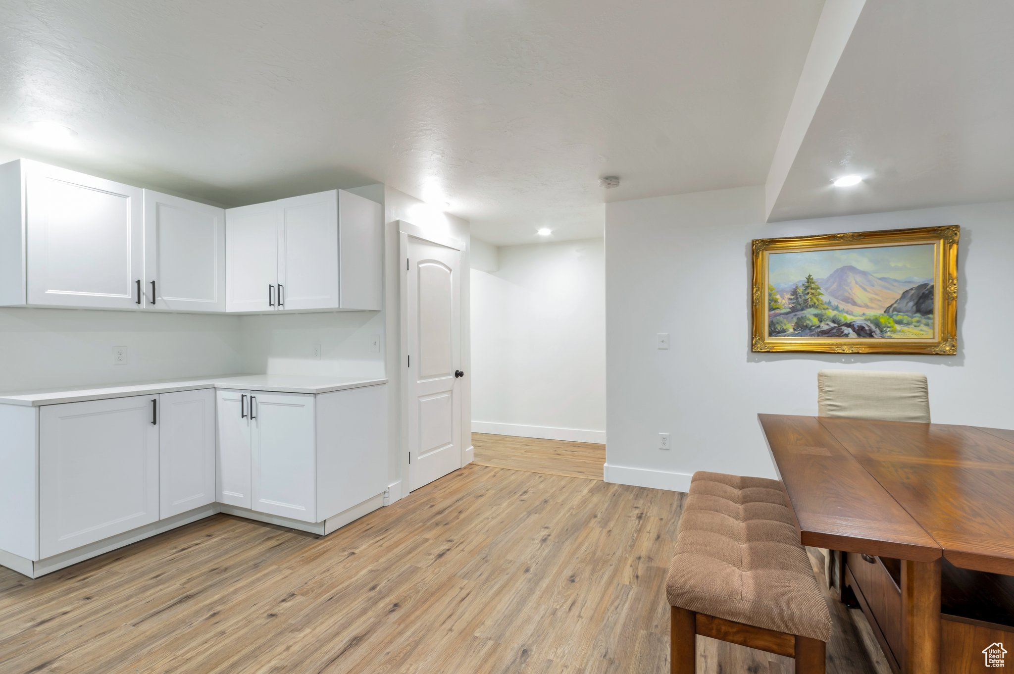 Kitchen featuring white cabinets and light hardwood / wood-style floors