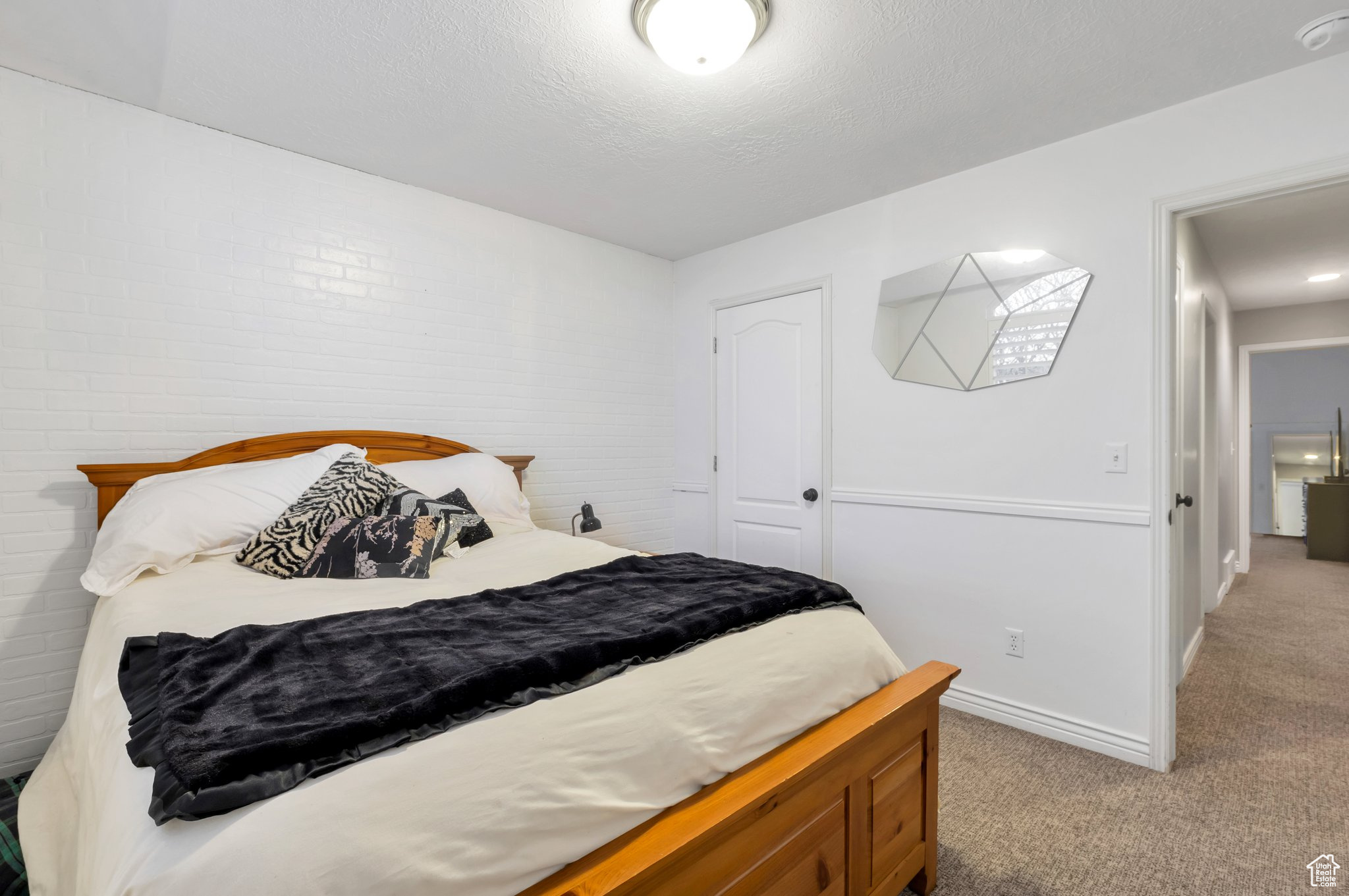 Carpeted bedroom featuring a textured ceiling