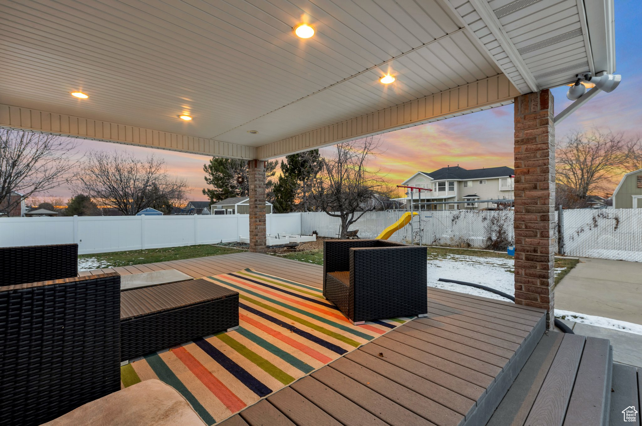 Deck at dusk featuring a playground