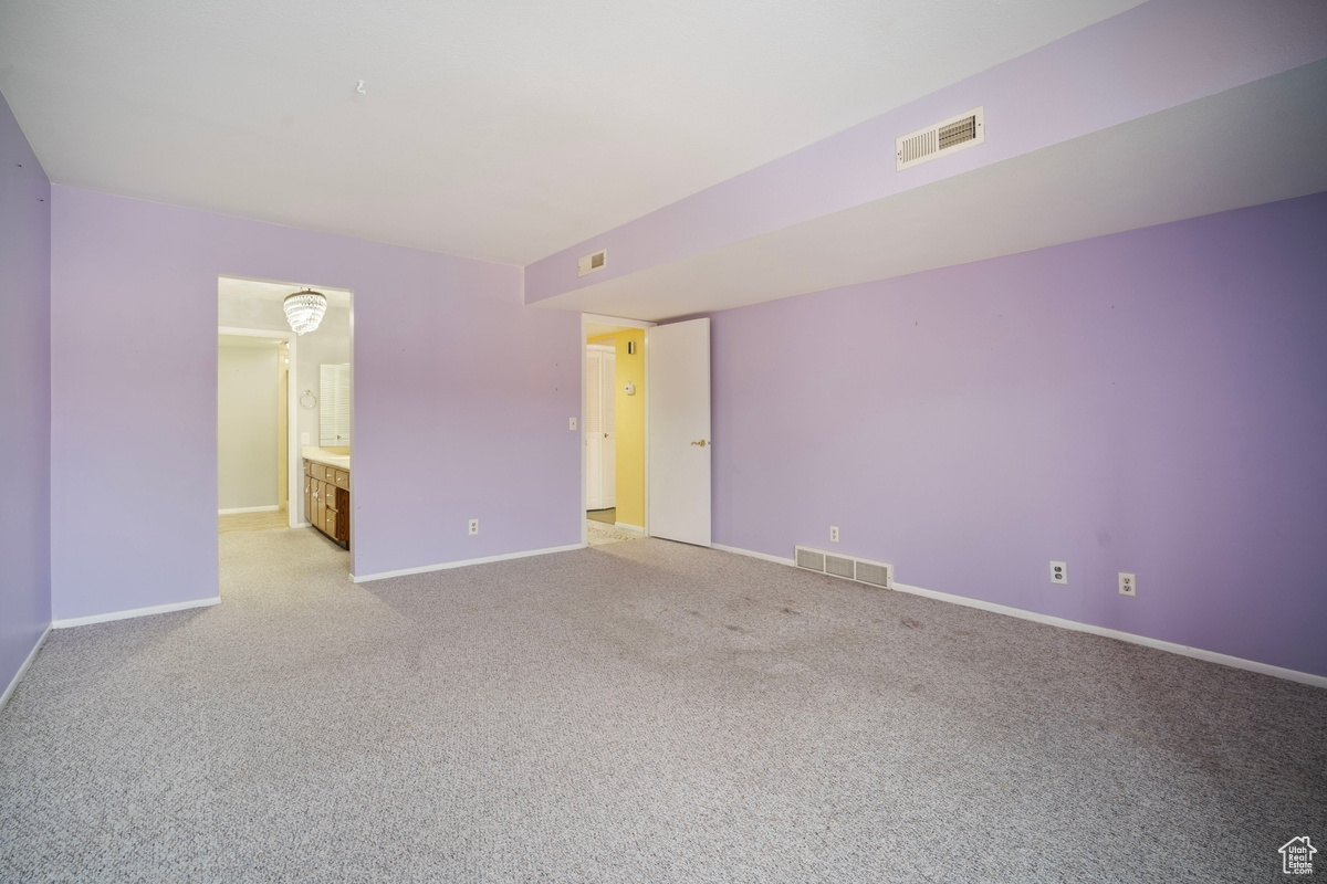 Empty room with light colored carpet