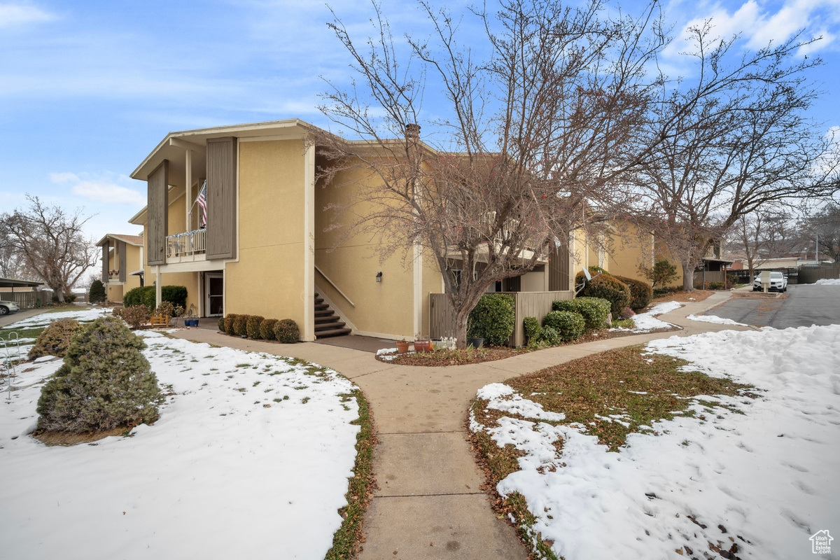 Snow covered property featuring a balcony