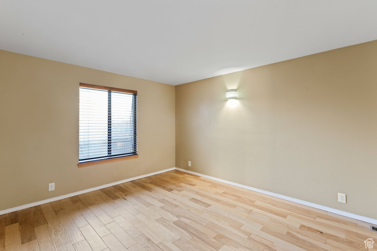 Unfurnished room with light hardwood / wood-style flooring