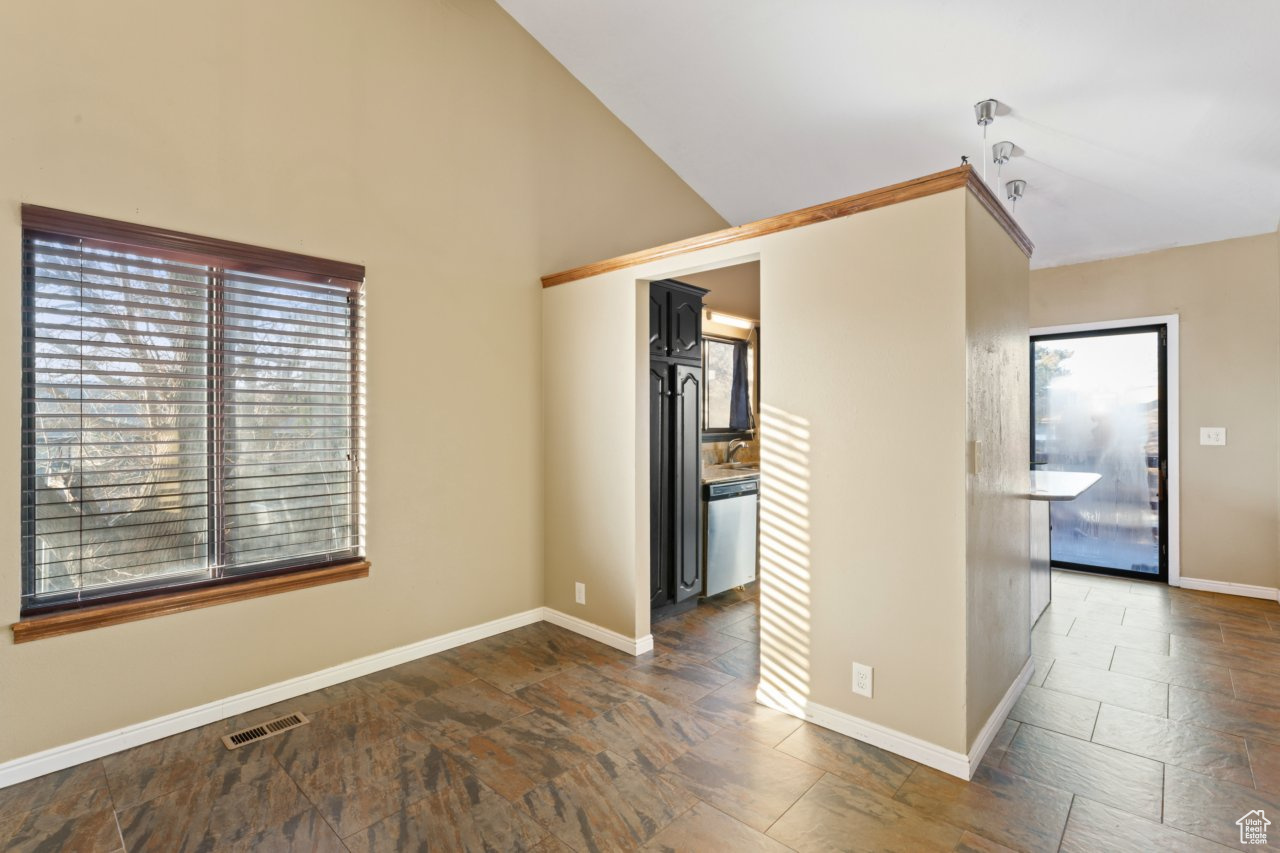 Spare room featuring lofted ceiling