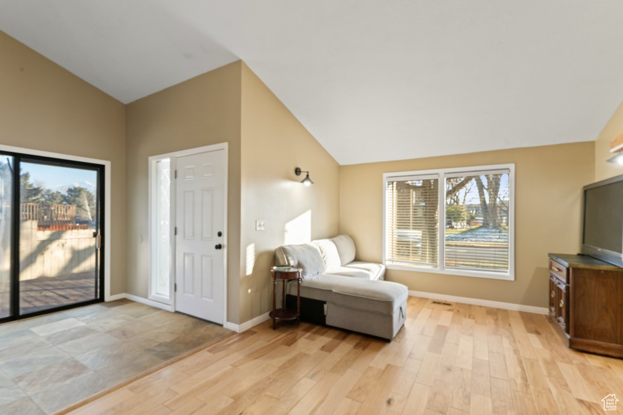 Entryway with lofted ceiling and light hardwood / wood-style flooring