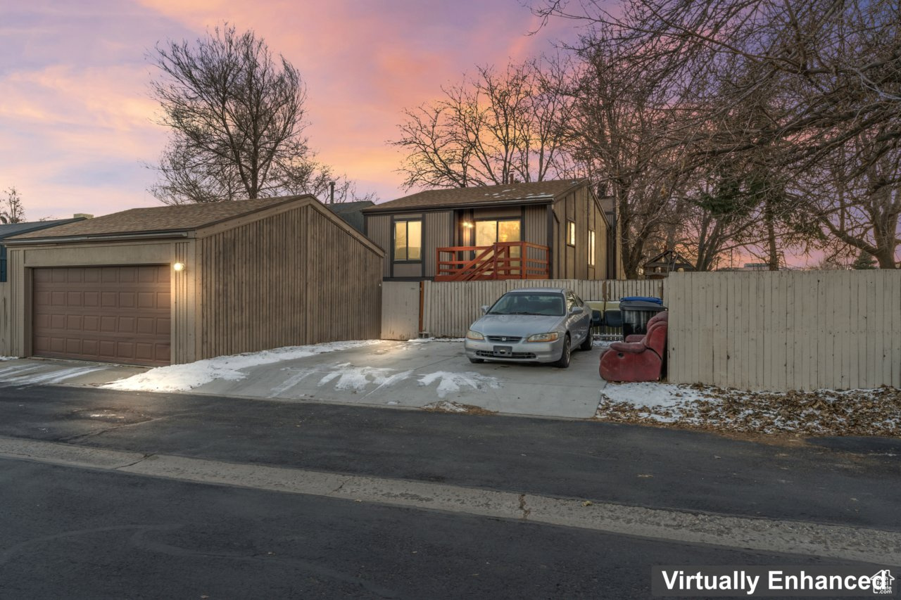 View of front facade with a garage and an outbuilding