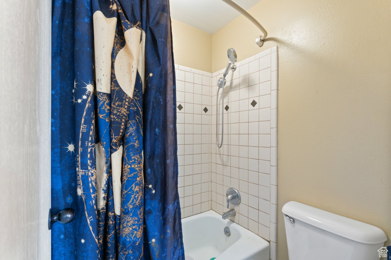 Bathroom with toilet and shower / tub combo