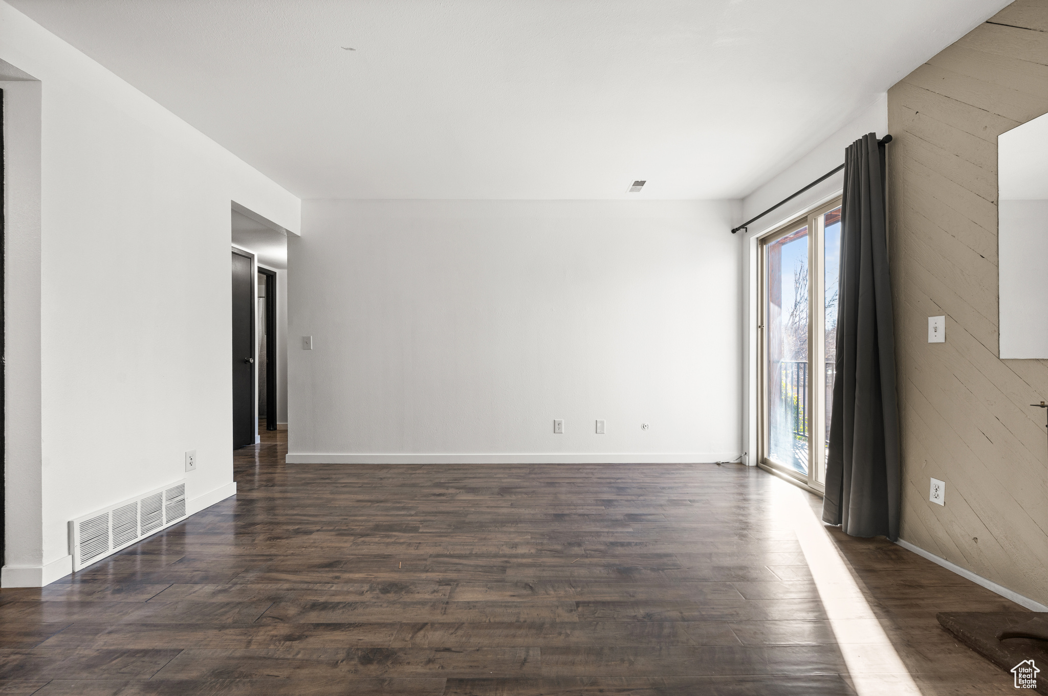 Unfurnished room featuring dark hardwood / wood-style flooring