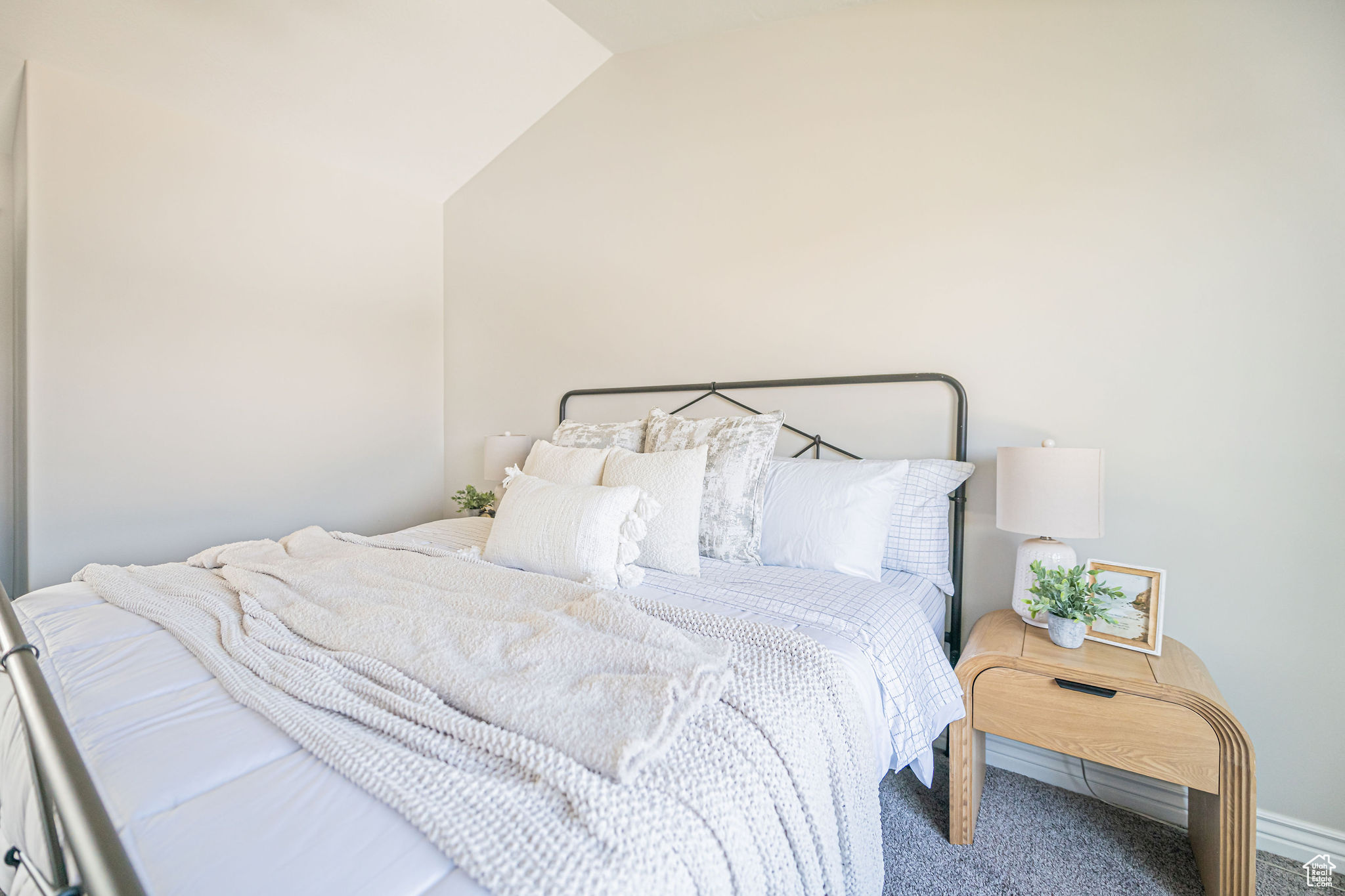 Carpeted bedroom featuring lofted ceiling