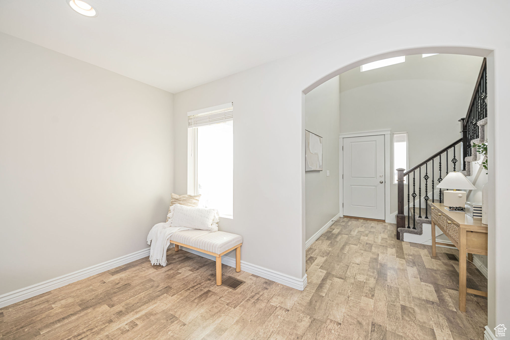 Entrance foyer with light wood-type flooring