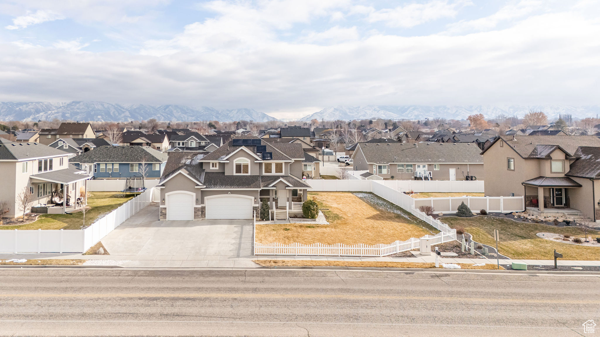 View of front of property with a garage and a mountain view