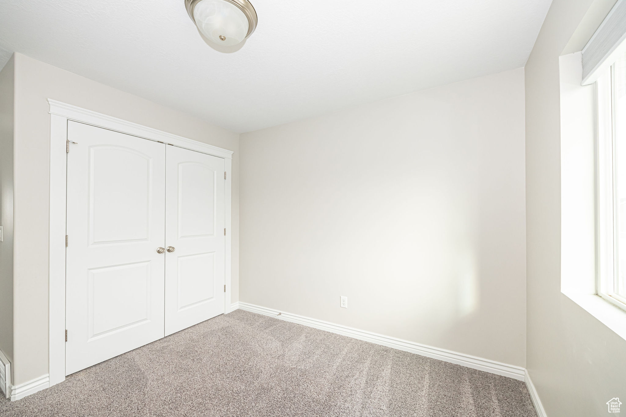 Unfurnished bedroom featuring a closet and carpet floors