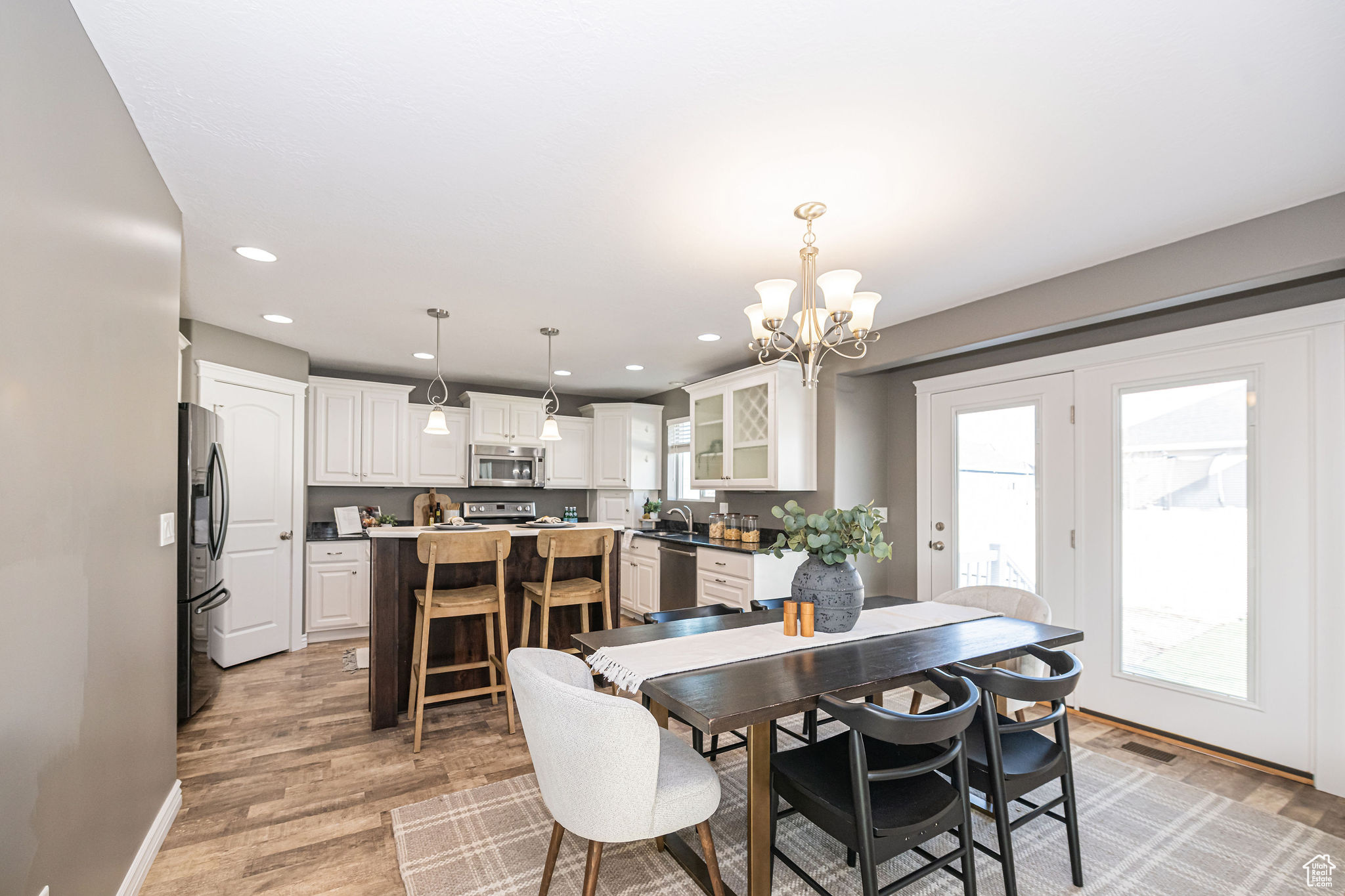 Dining room featuring an inviting chandelier and light hardwood / wood-style flooring