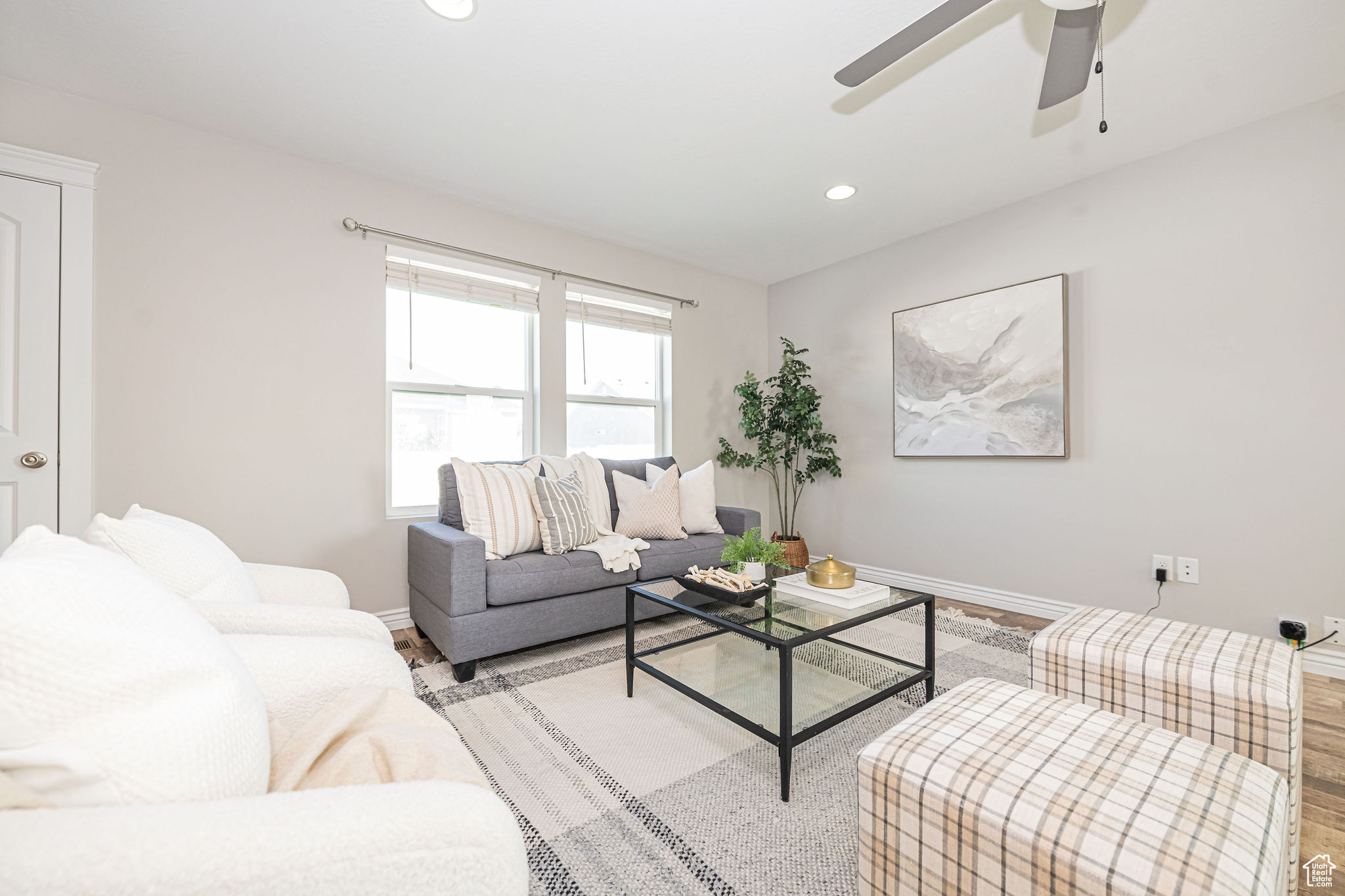 Living room with ceiling fan and light wood-type flooring