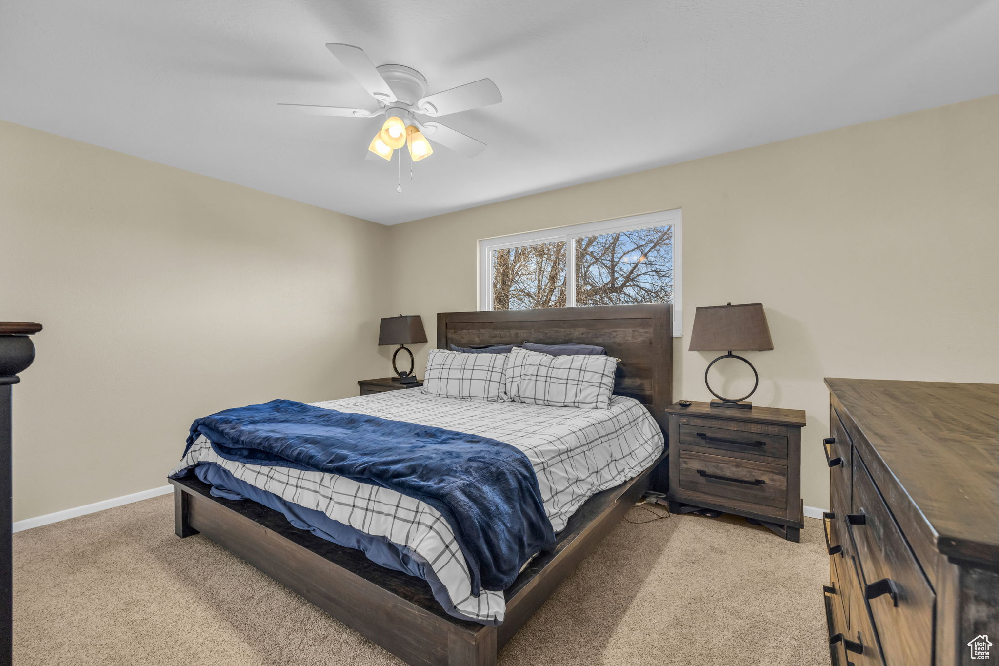 Bedroom featuring ceiling fan and light carpet