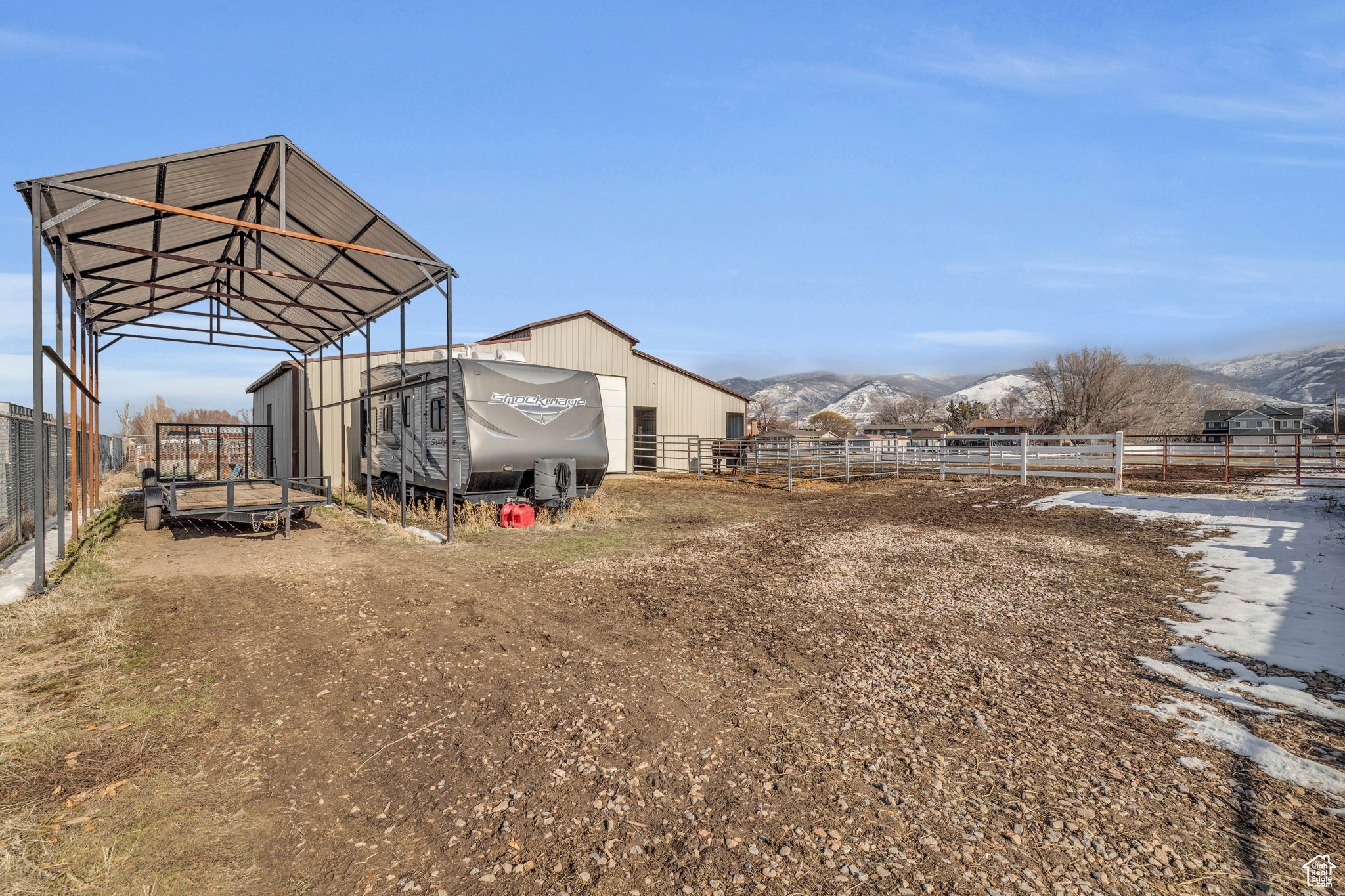 View of yard with a rural view, a mountain view, and an outdoor structure