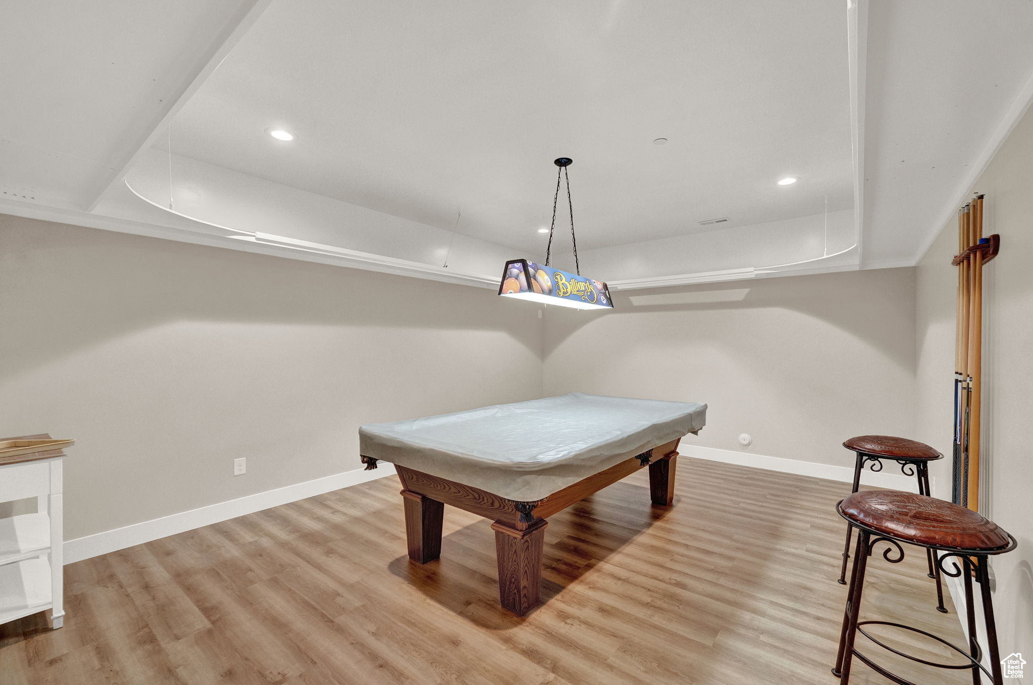 Rec room with light wood-type flooring, a tray ceiling, and billiards