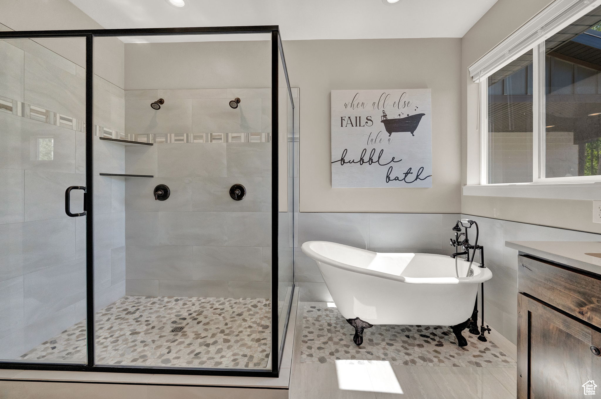 Bathroom featuring plus walk in shower and vanity