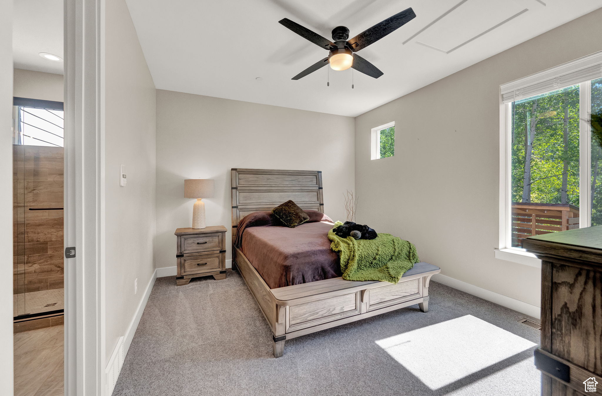 Carpeted bedroom with ceiling fan