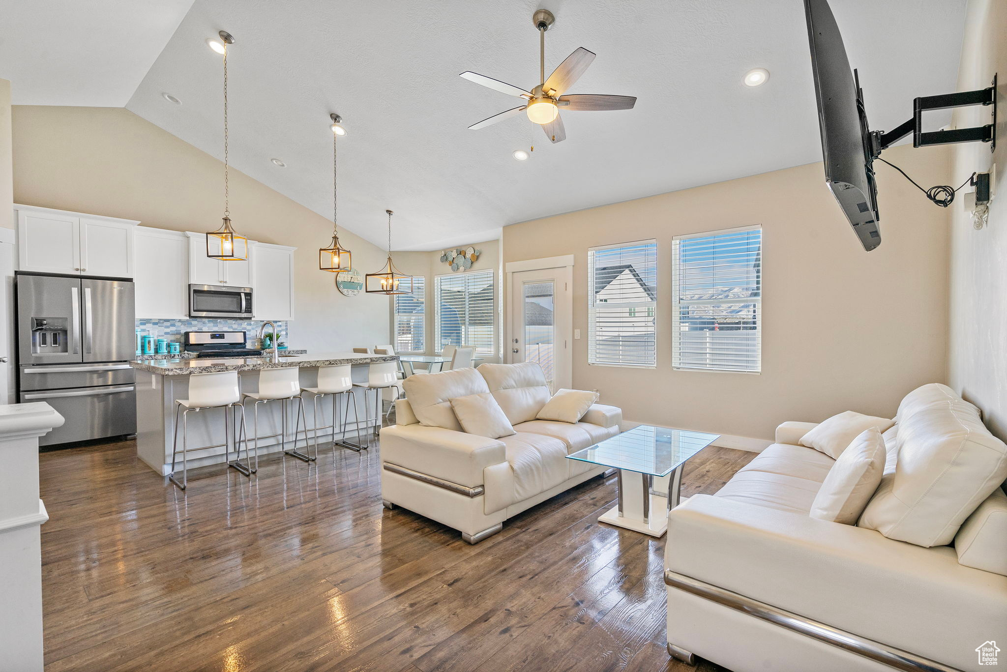 Living room with sink, dark hardwood / wood-style flooring, ceiling fan, and vaulted ceiling