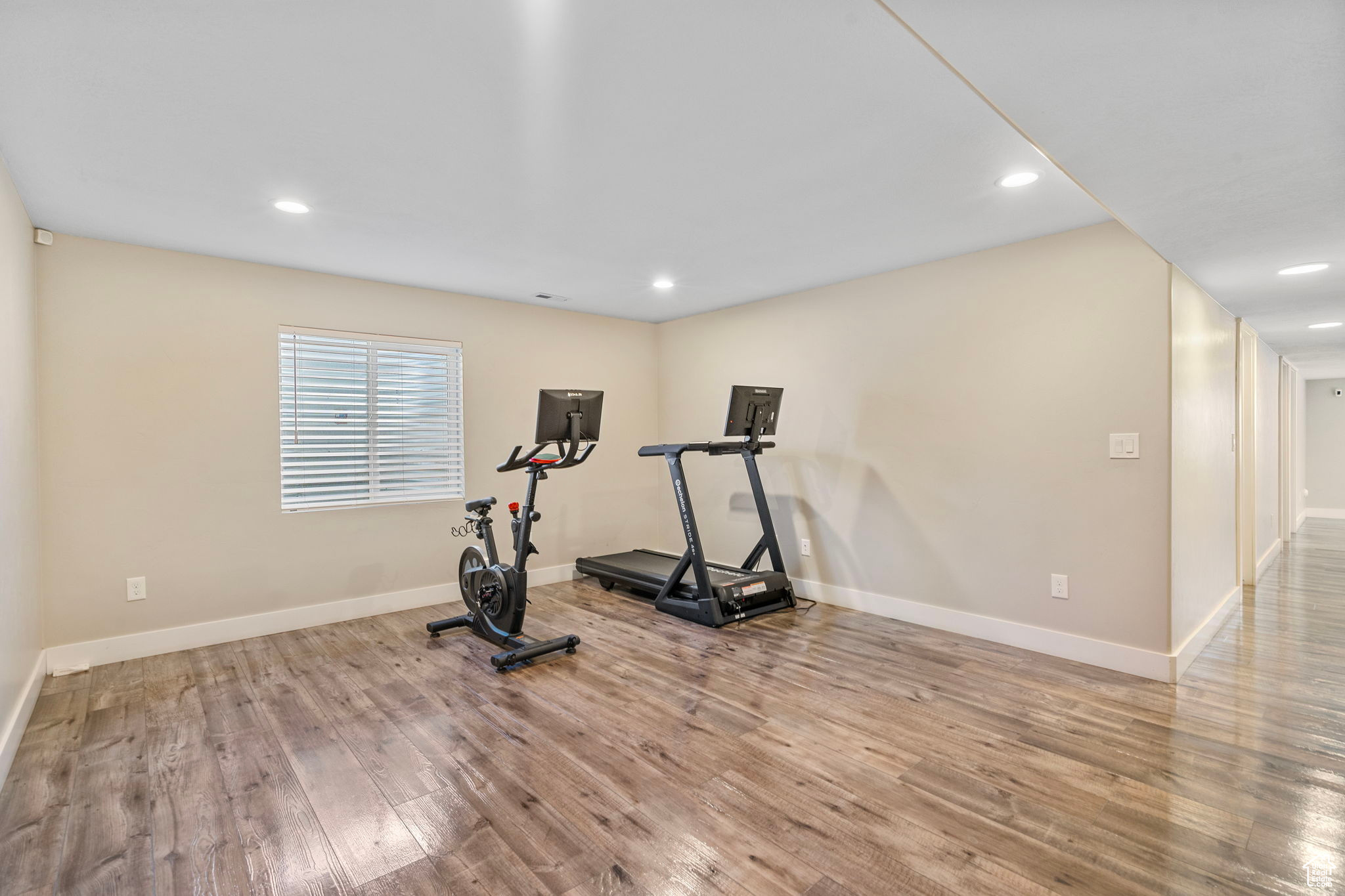 Workout area featuring light hardwood / wood-style flooring