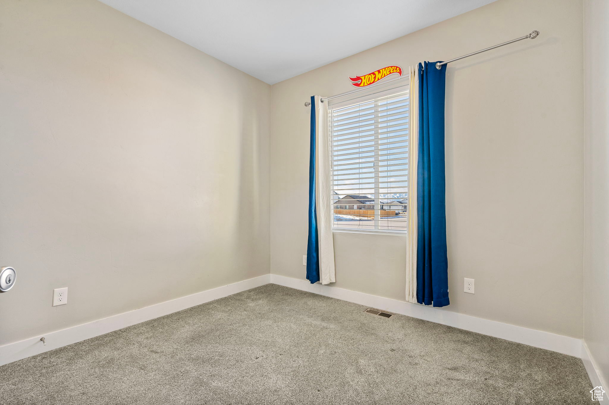 Spare room featuring carpet flooring