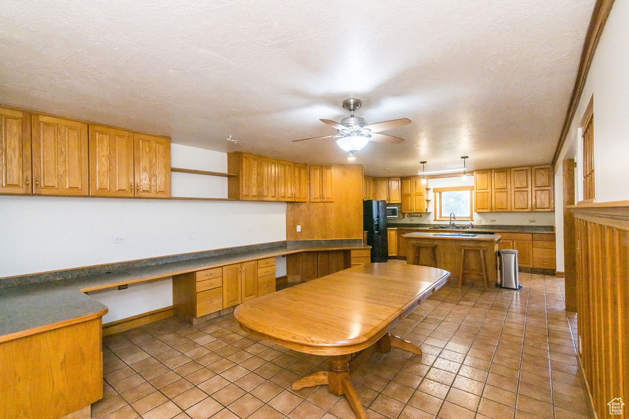 Kitchen / Dining  with built in desk, a kitchen island, and large dining area perfect for large gatherings.