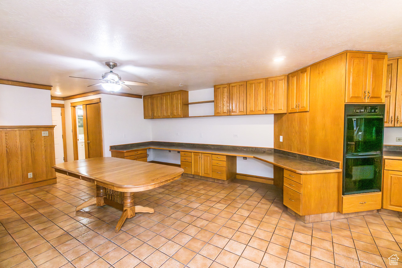 Kitchen with double oven, and desk area with built in desk