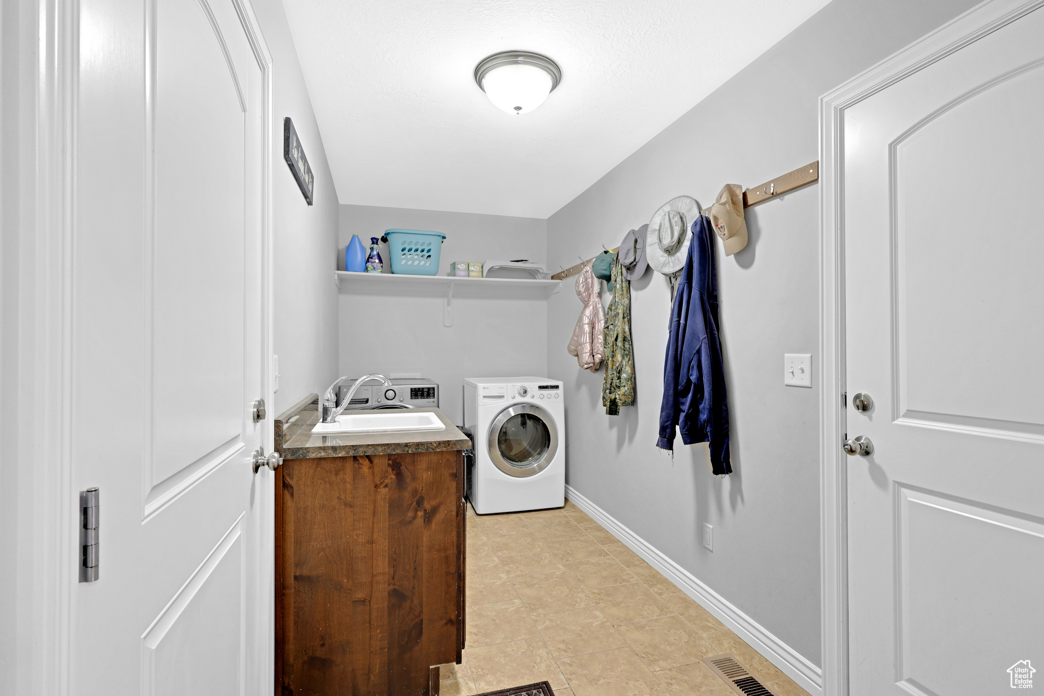 Clothes washing area with independent washer and dryer and sink